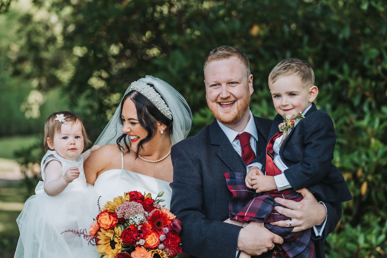 Wedding portrait with small children against green foliage background at Oswald House, Kirkcauldy.