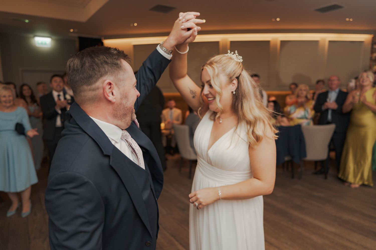 A couple shares their first dance at a wedding reception while guests watch from the background Glasgow's Merchant City.