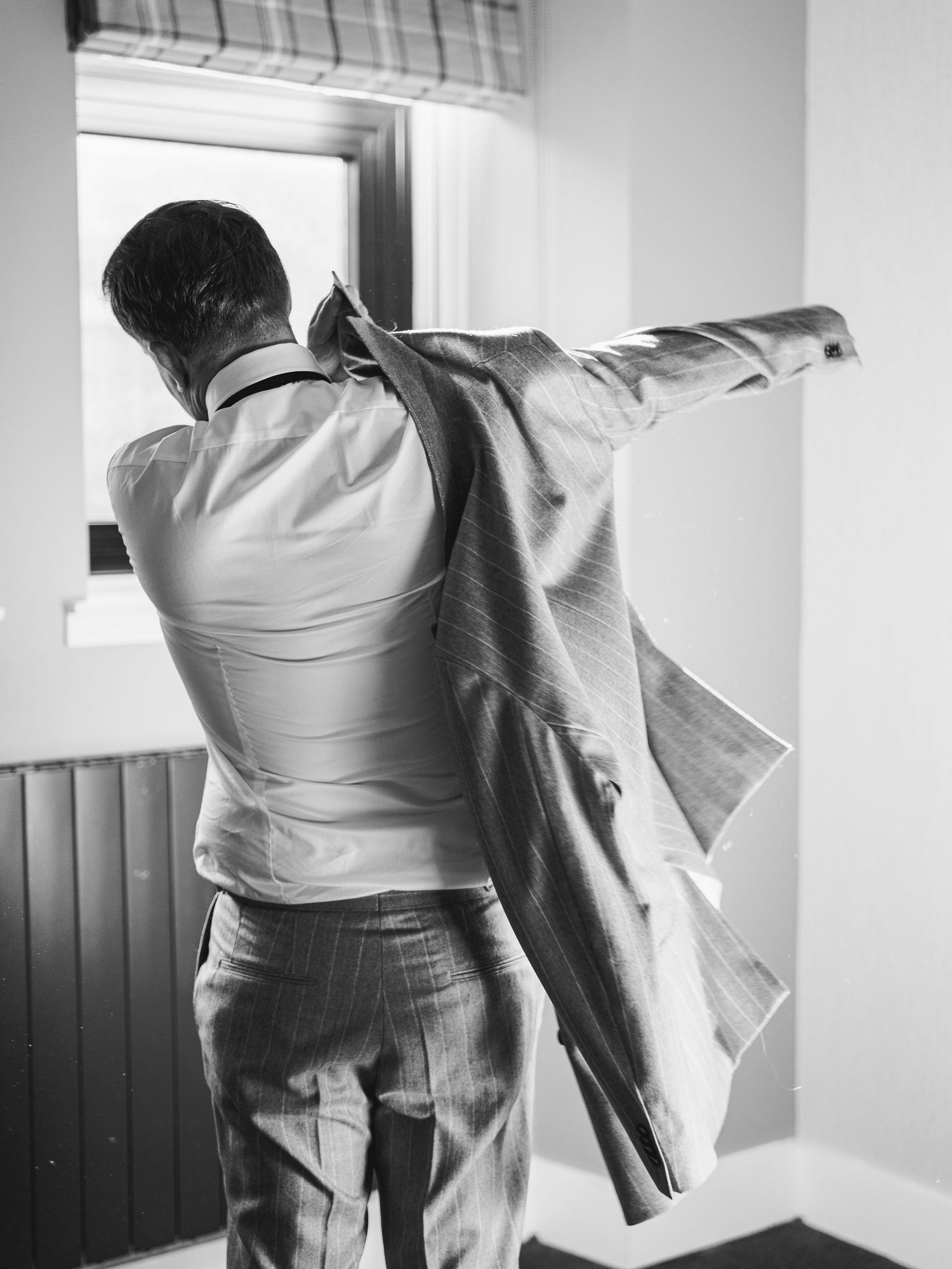 Black and white photos showing motion and movement during wedding day preparations.