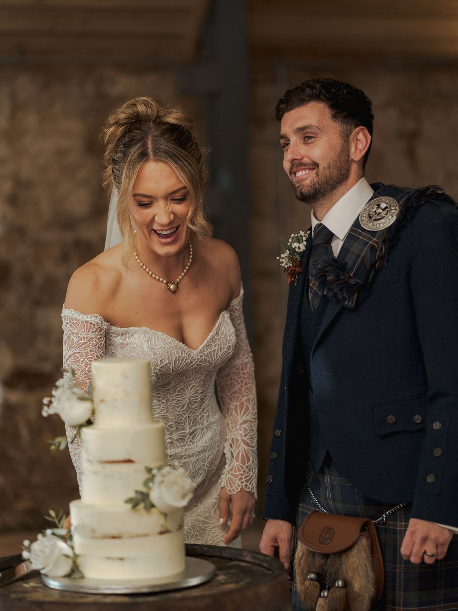 A series of wedding cake cutting moments showing a traditional white tiered cake with rustic decorations at Falside Mill.
