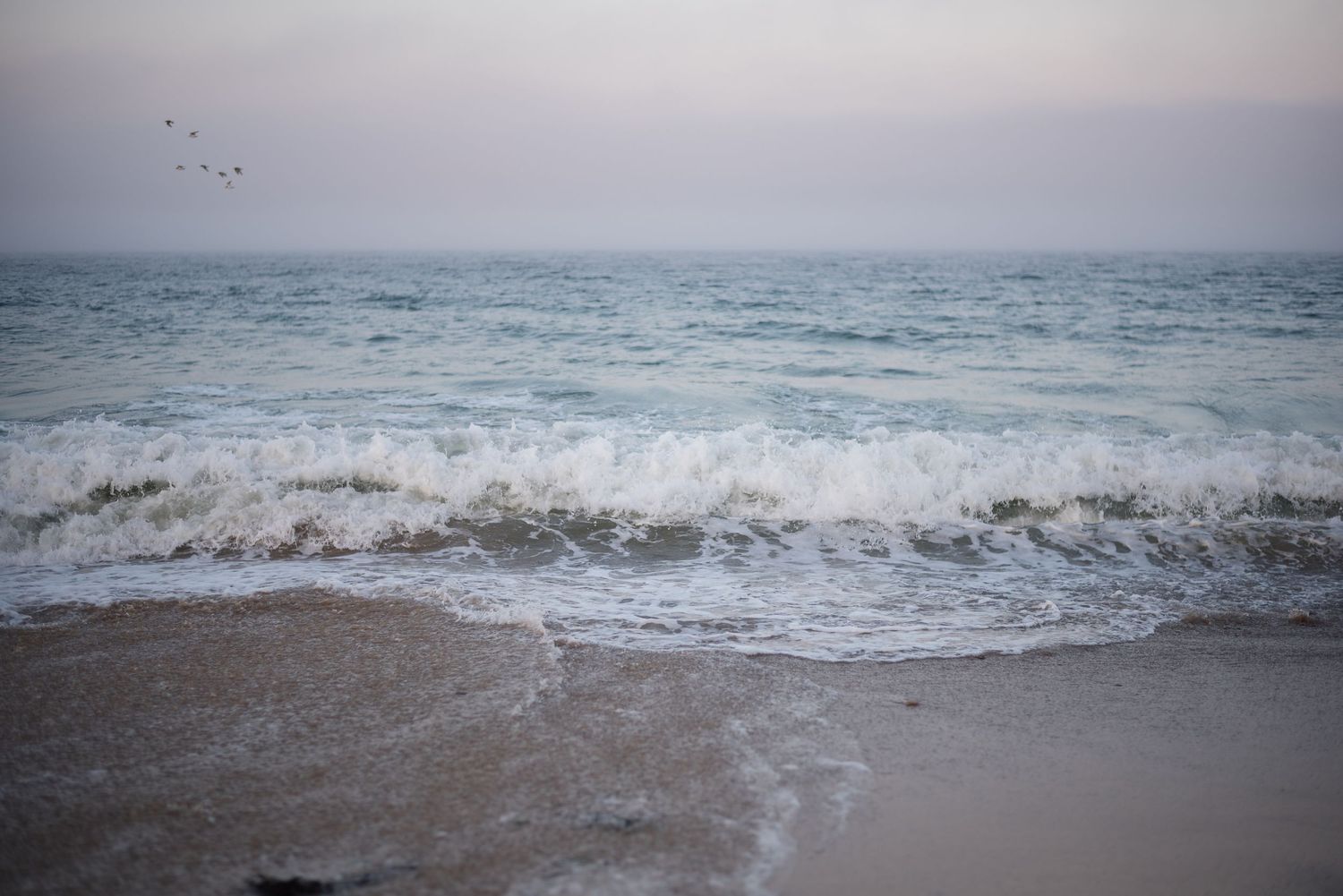 Ocean waves crash against the shore in a series of calming seascape photographs.
