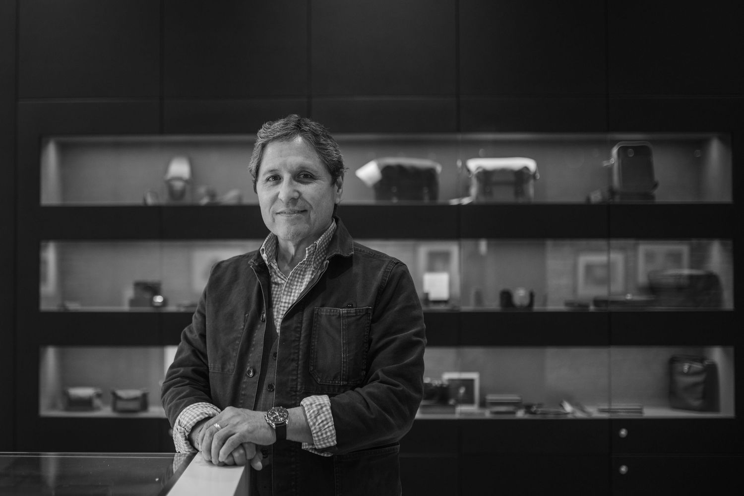 A series of black and white studio portraits showing different facial expressions in moody lighting.