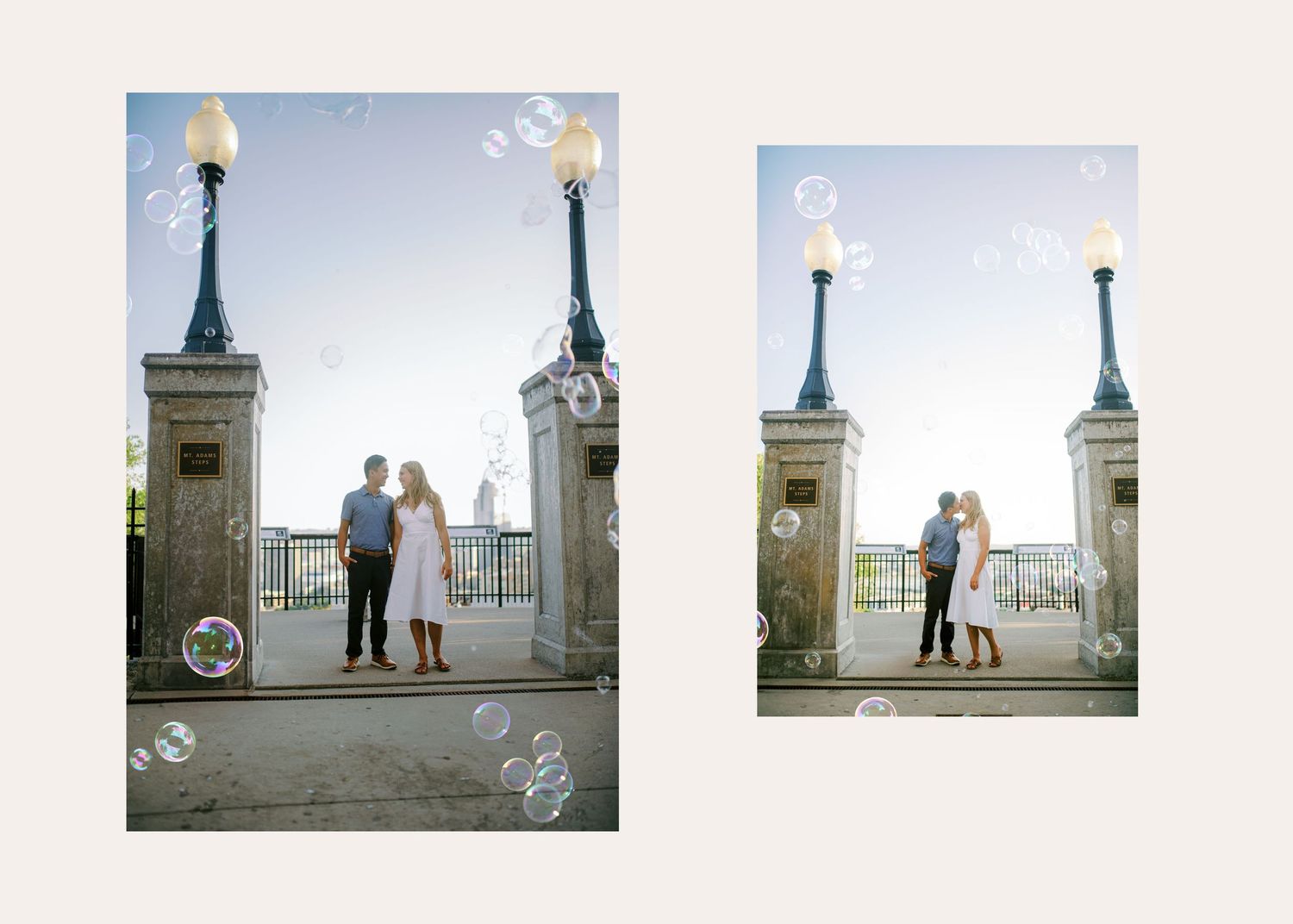 Two people stand against a romantic city backdrop with bubbles floating around them on a cobblestone terrace at dusk.