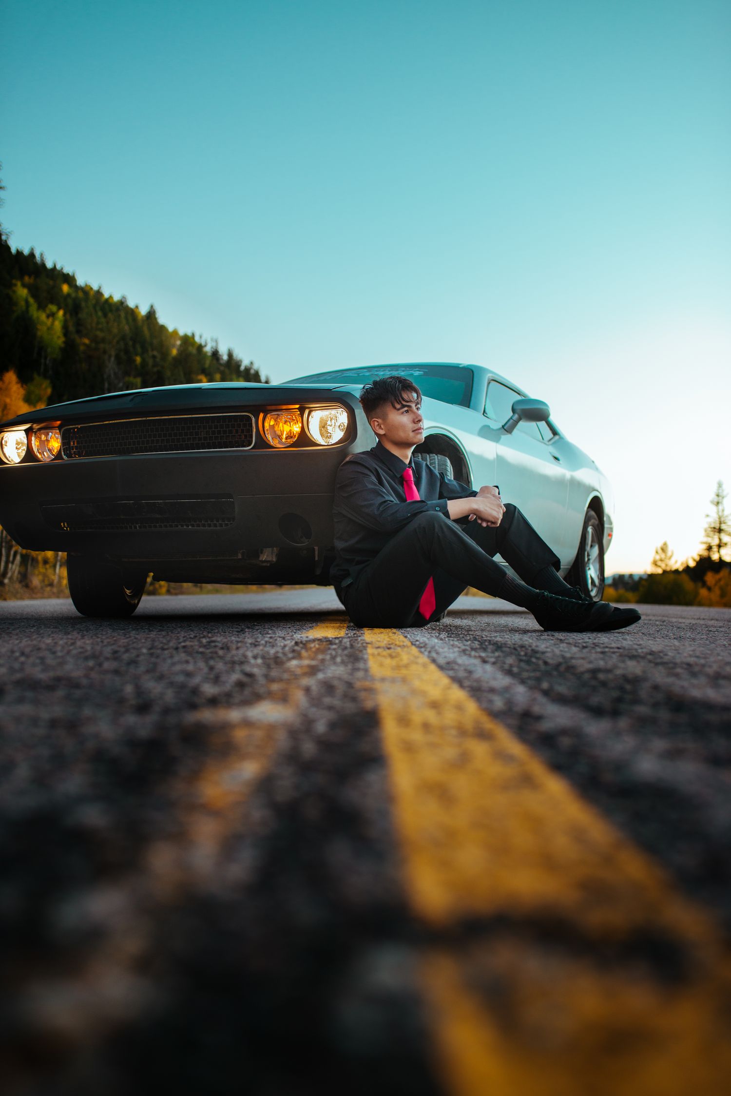 Creative low-angle car photography with classic muscle car against blue sky.