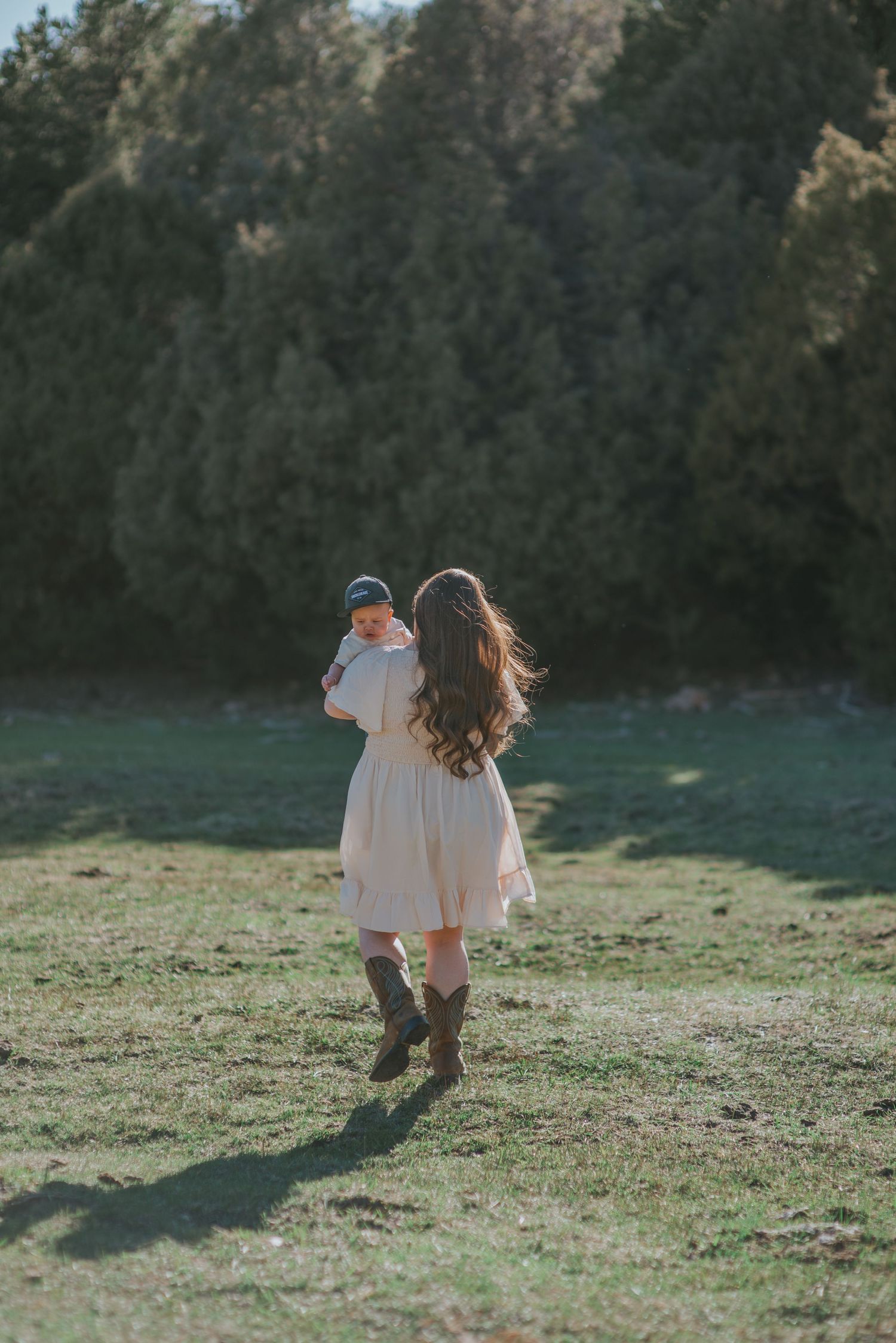 Mom and 1-year-old baby under pine trees in northern New Mexico — gentle, emotive image by Quiet Light by The Amoras.