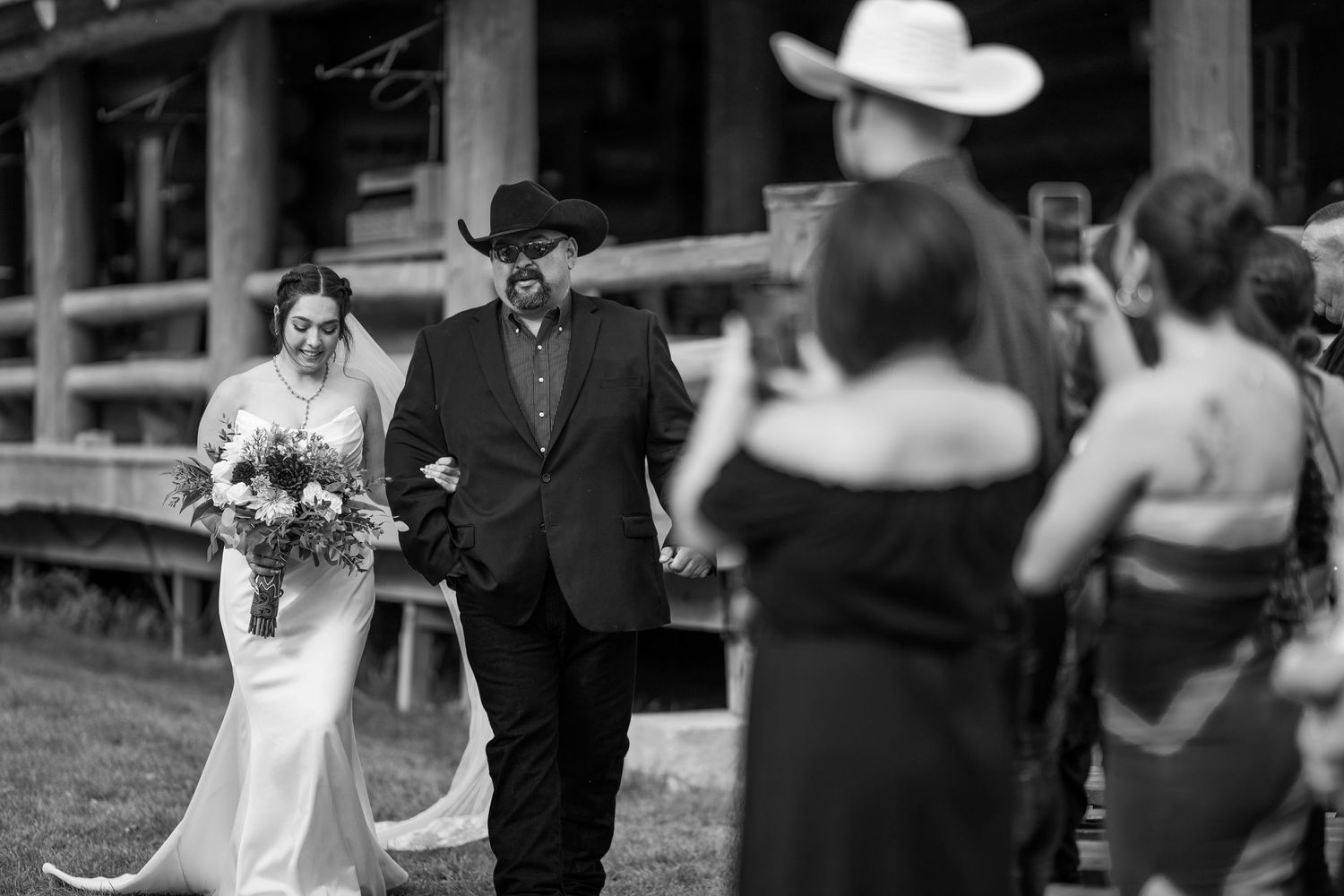 Black and white photograph of a western-themed wedding procession.