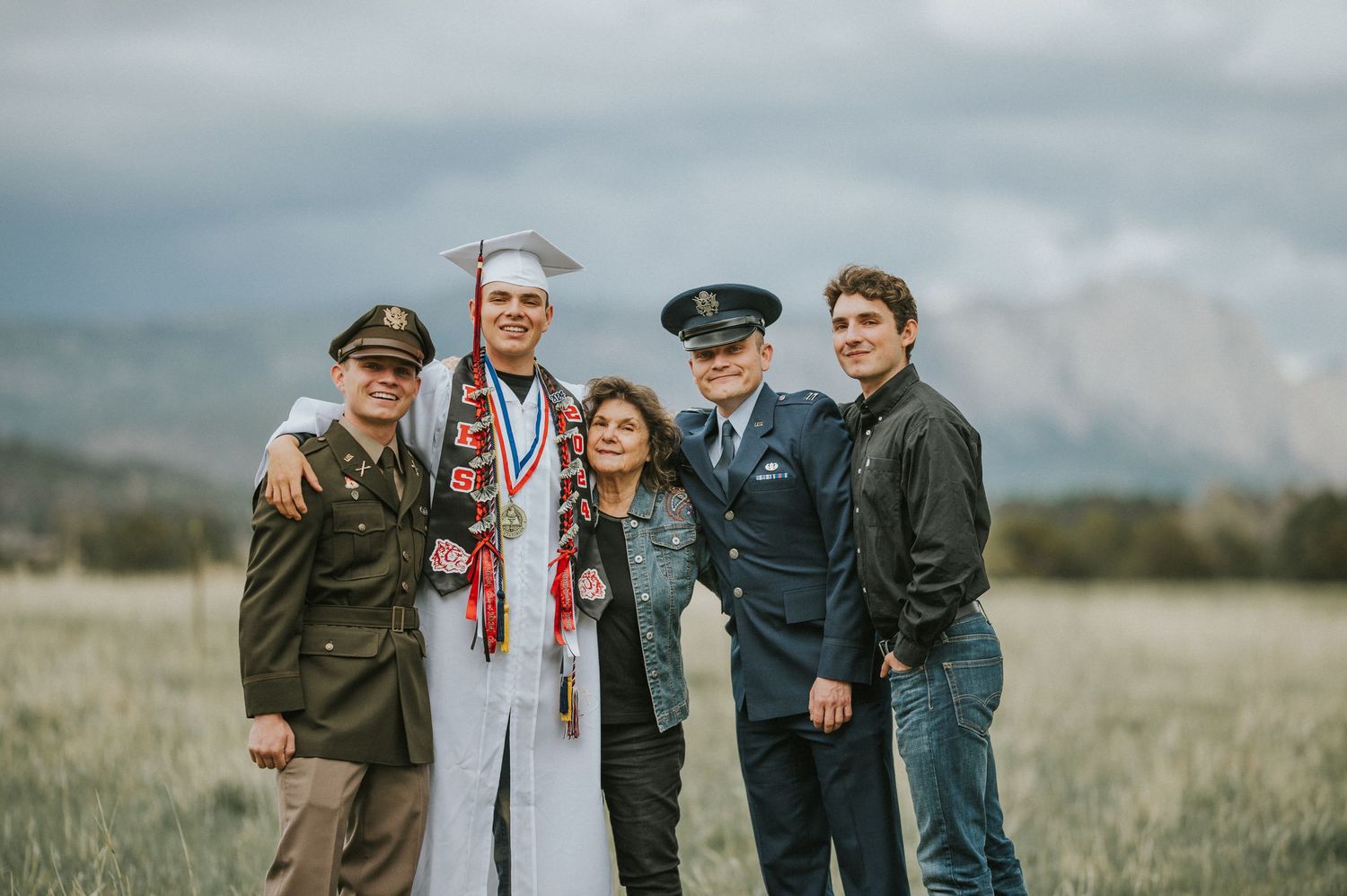 Grandma and her four grandsons, celebrating achievements in education and service — natural light portrait by The Amoras.