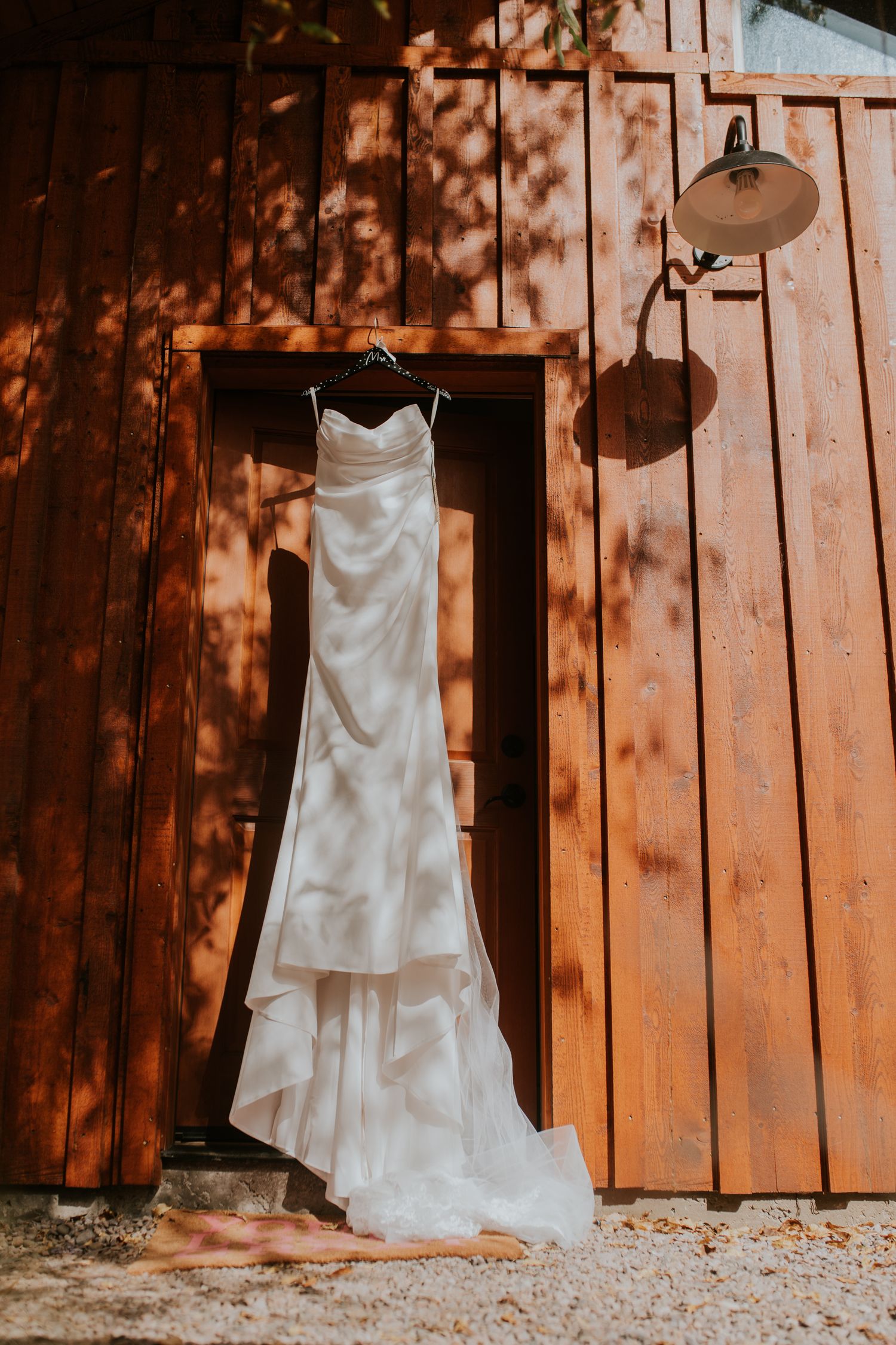 Wedding dress on display in a rustic barn in Chama — soft, natural light image by Quiet Light by The Amoras.