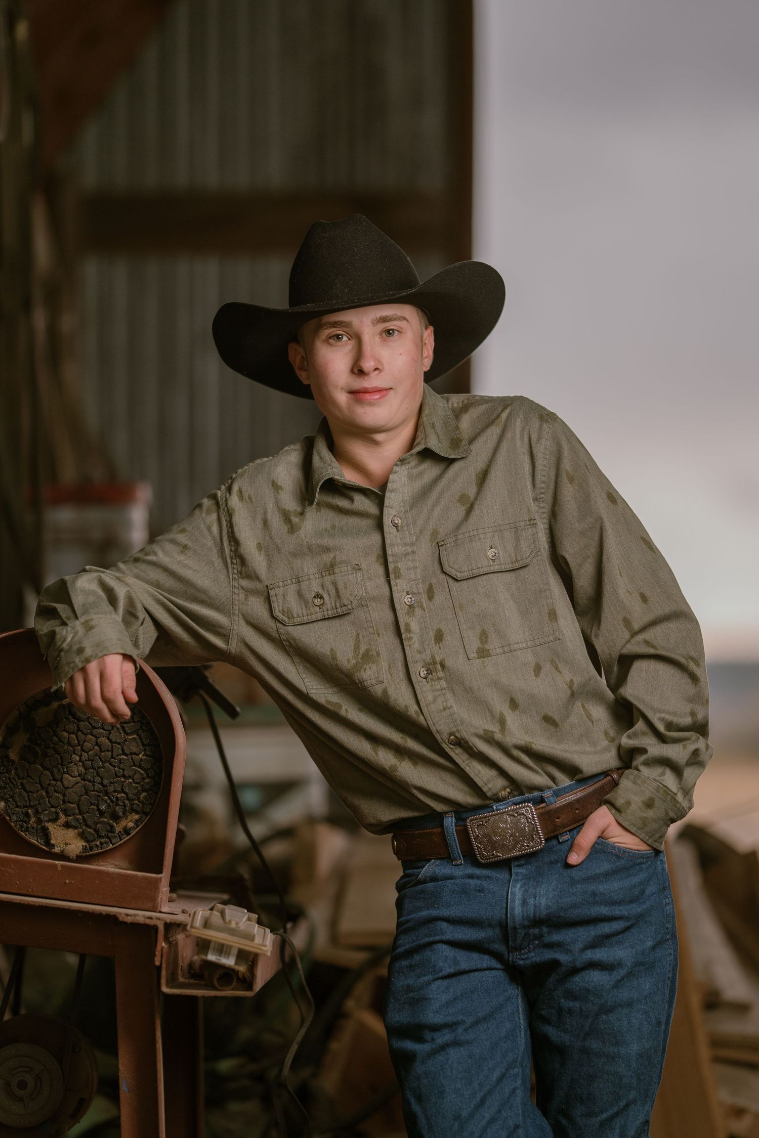 Modern western style portrait series showing rustic clothing and cowboy hat against wooden background.