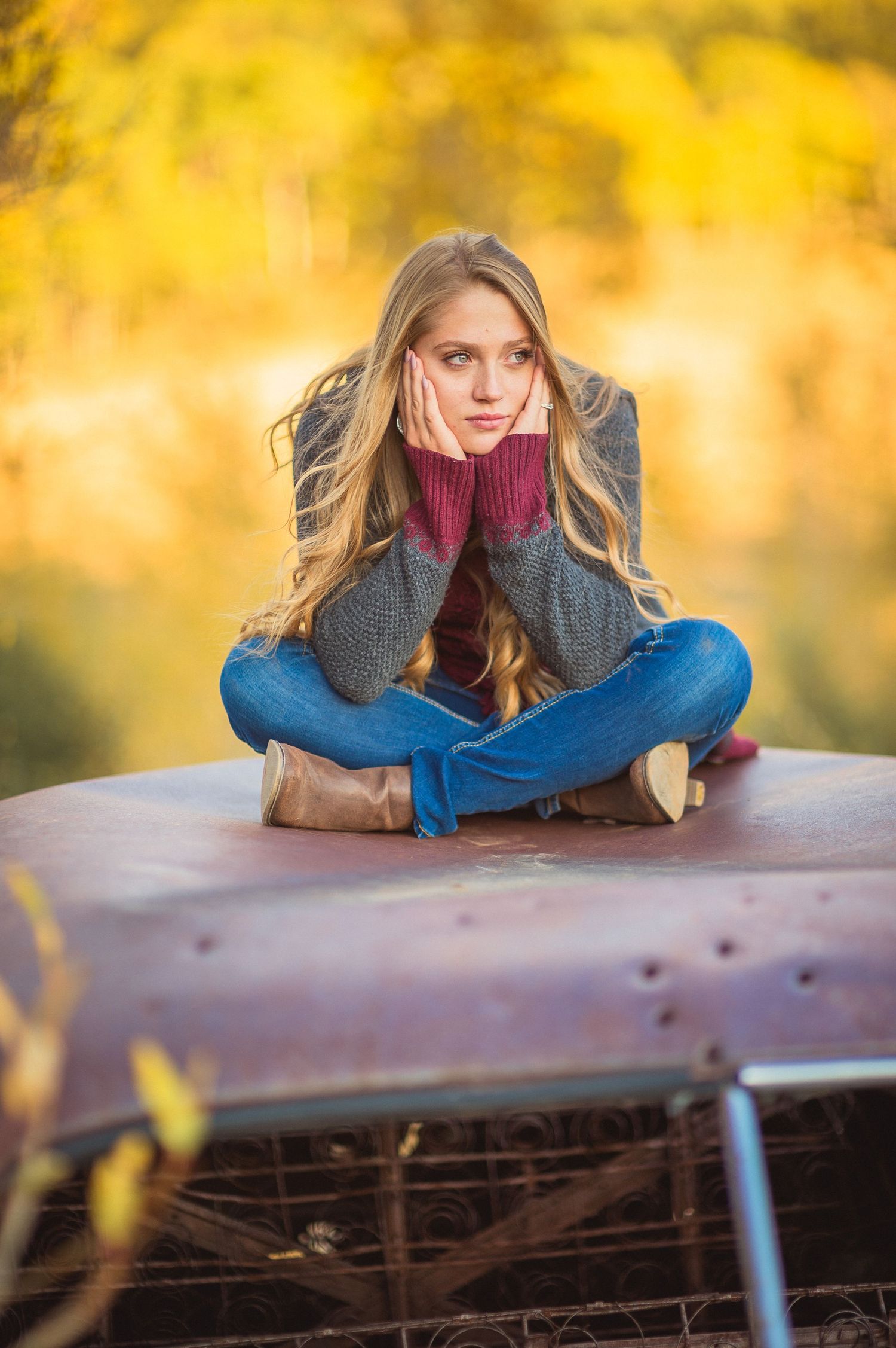 Autumn outdoor portrait series with soft golden bokeh background showing different relaxed poses on wooden railing.