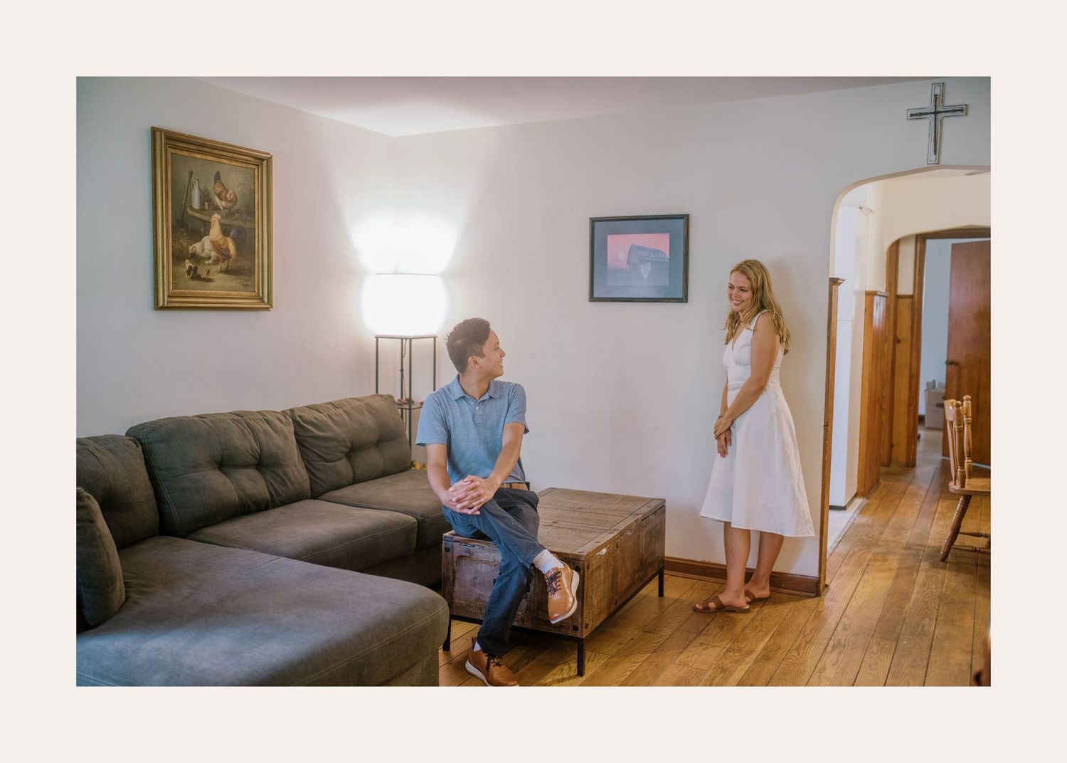 A heartwarming living room scene shows someone on couch watching as someone performs joyful ballet-like movements.