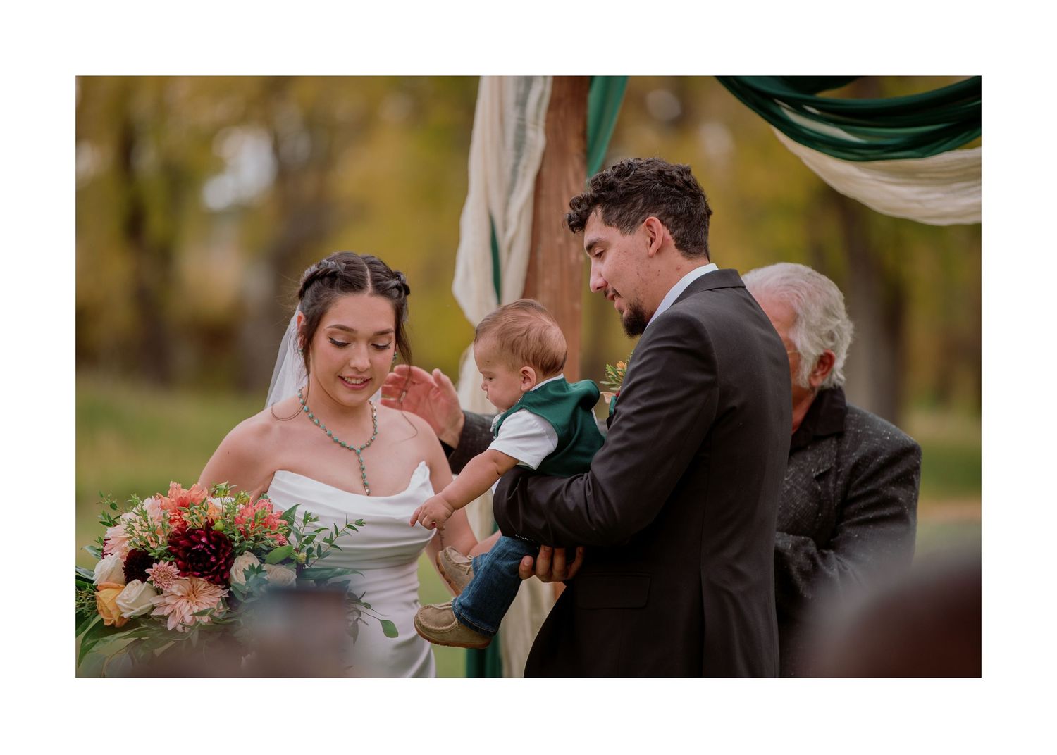 Wedding ceremony participants gathered at a decorated outdoor altar during an autumn celebration.