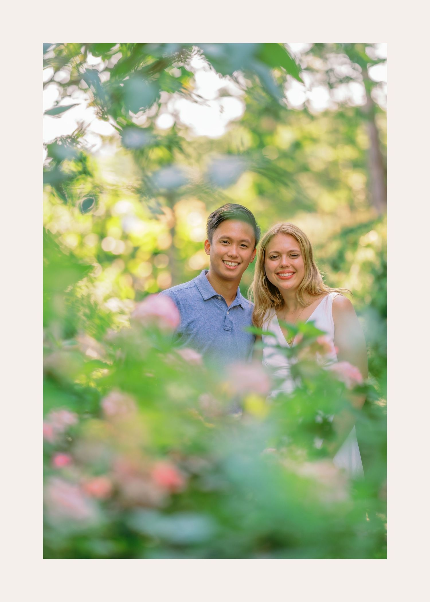 A couple shares romantic moments in a lush garden setting with soft bokeh effects and natural sunlight filtering through leaves.