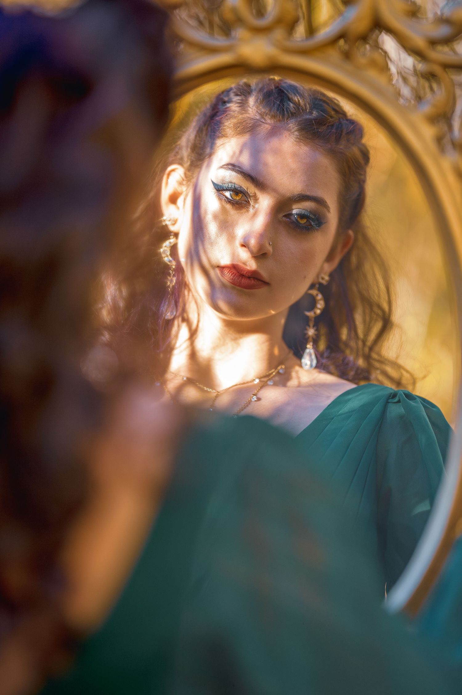 Portrait in emerald green dress with dramatic lighting and ornate golden frame creating an elegant vintage aesthetic.