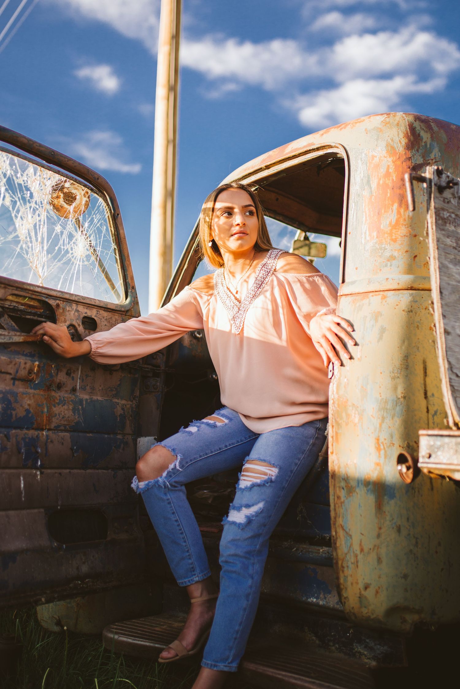 A rusted metal structure photographed in sequence with a pink sunset sky in the background.