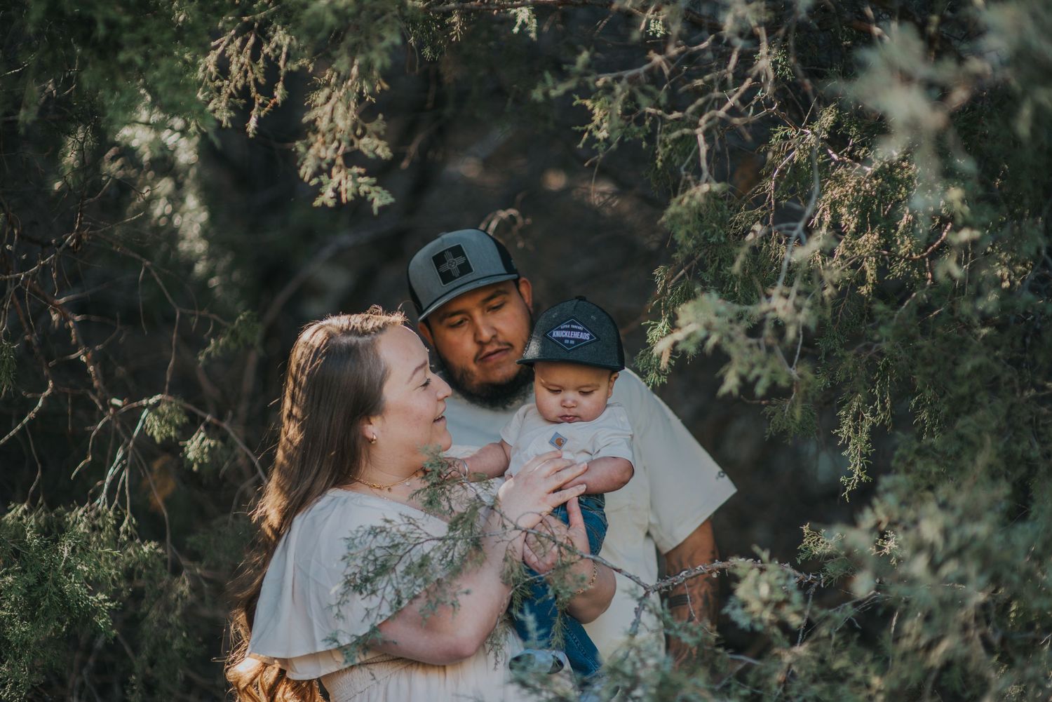 Mom and dad walking with their toddler son in a serene forest setting near Santa Fe — heartfelt storytelling by Quiet Light by The Amoras.