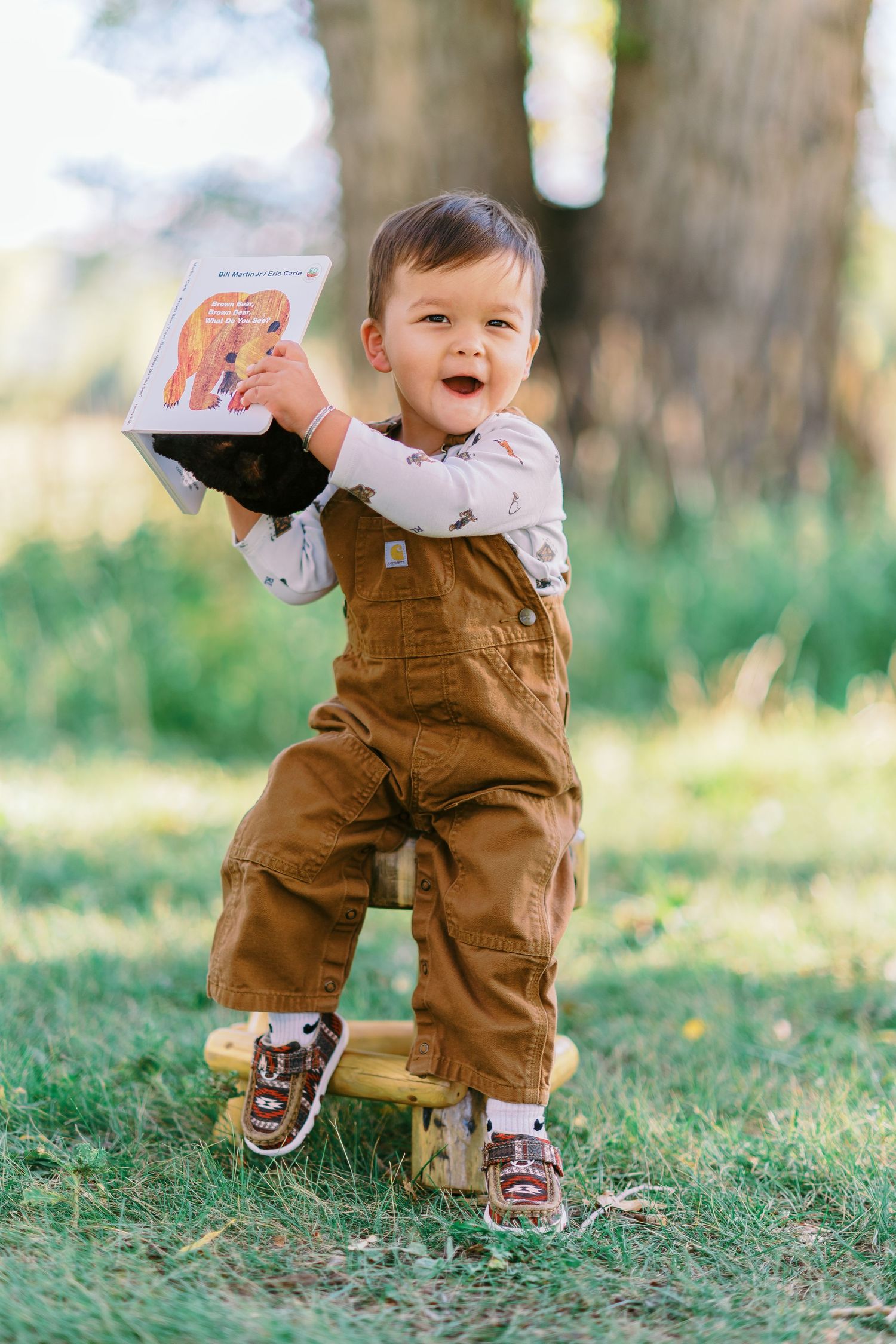 Small feet in brown overalls and shoes take wobbly steps on grass in a series of progression shots.