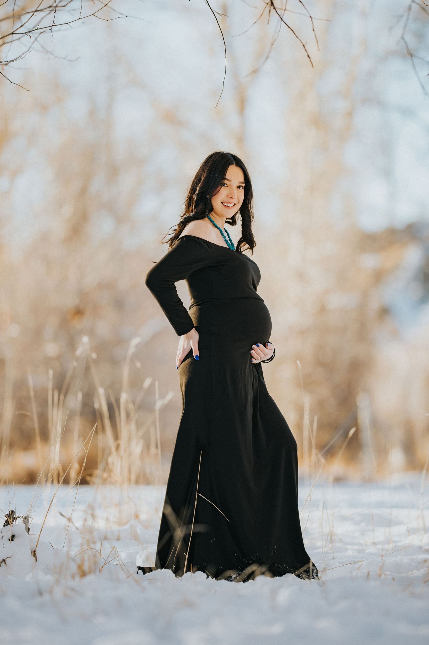 Portrait of an expecting mother standing quietly in natural light during a maternity session in Chama, New Mexico — captured by Quiet Ligh