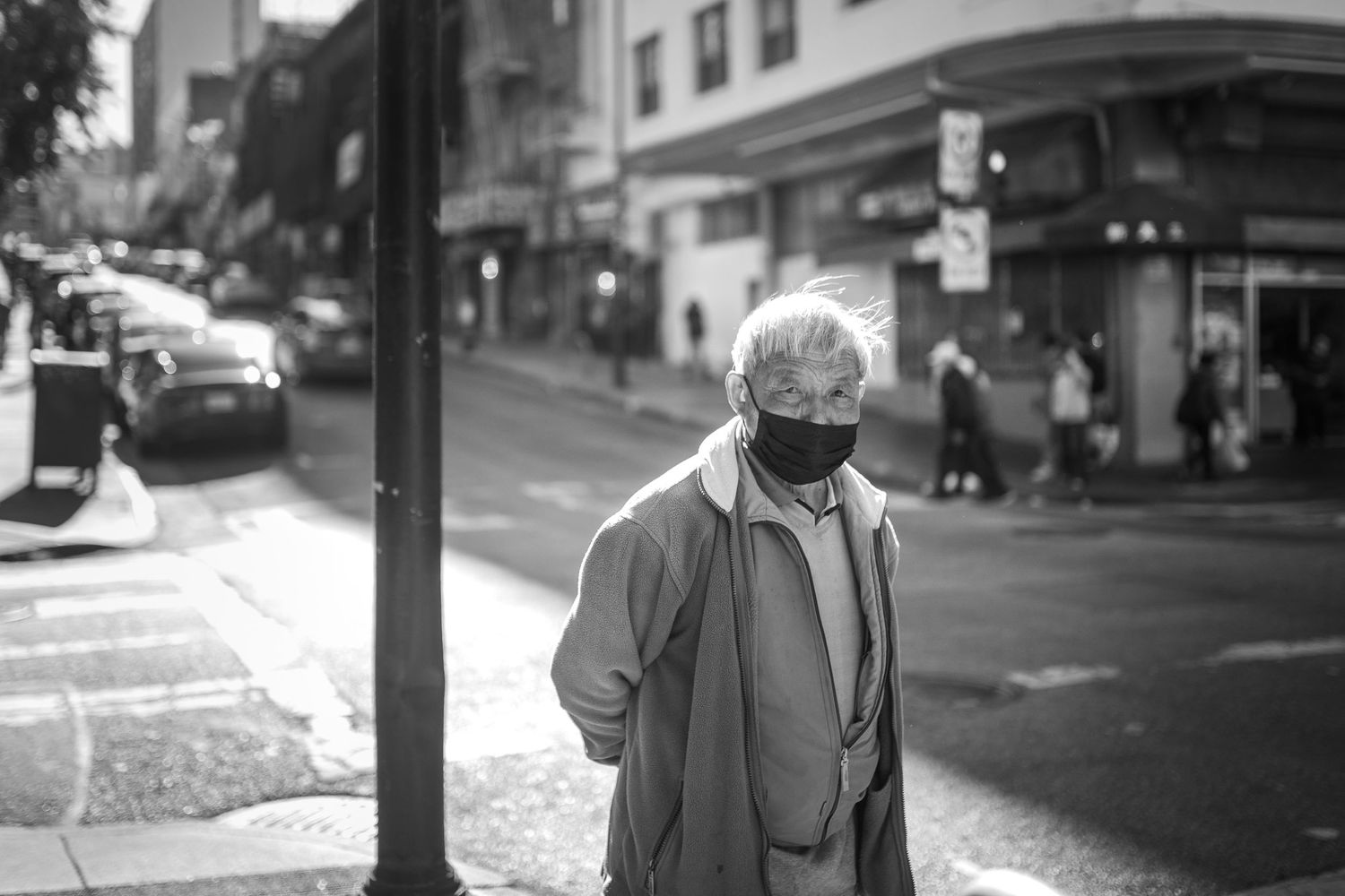 Collage of black and white street photographs showing people walking on city sidewalks and crossing streets in urban settings.