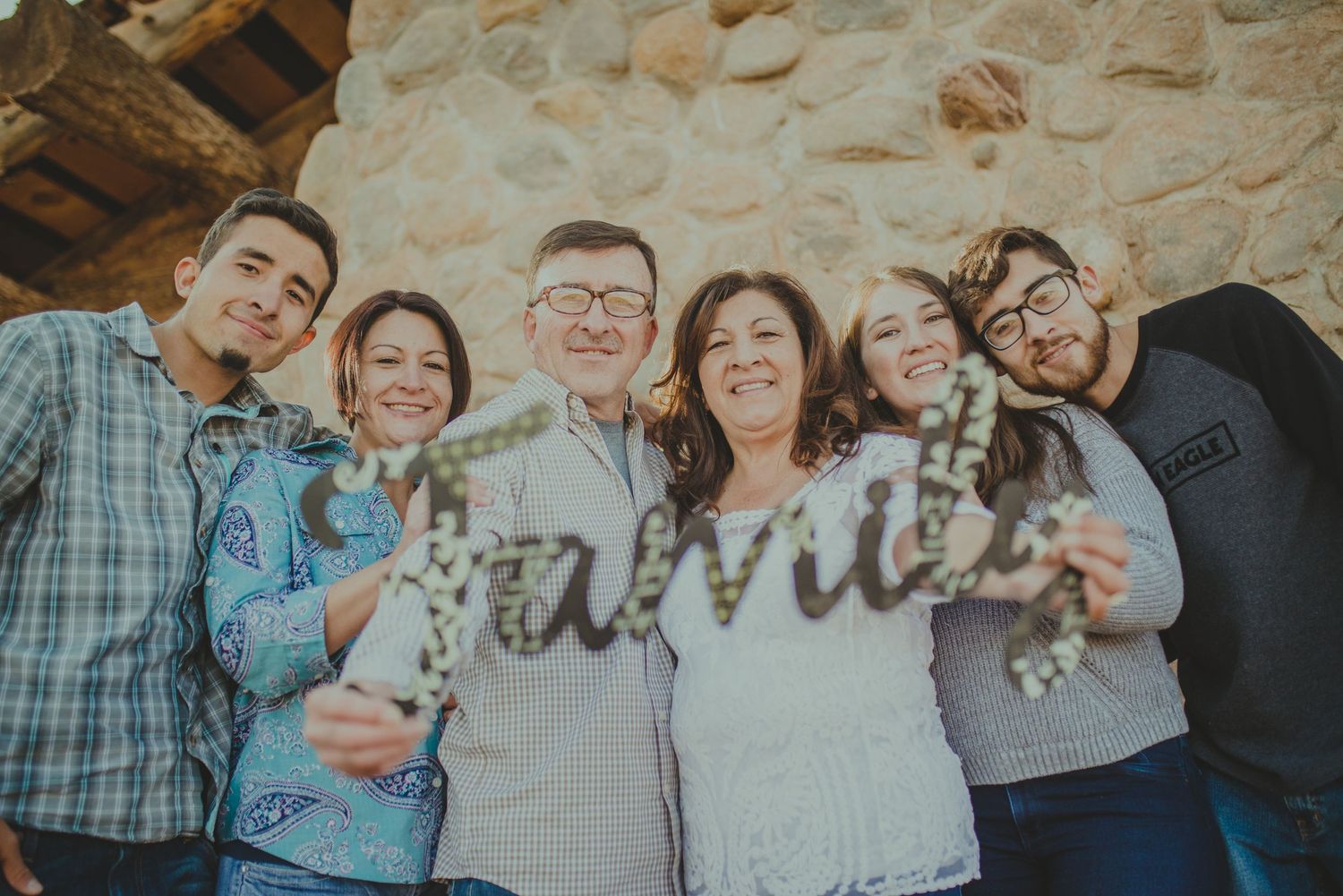 Parents with two sons and two daughters embracing in the open desert plains of Abiquiú — serene and heartfelt image by The Amoras.