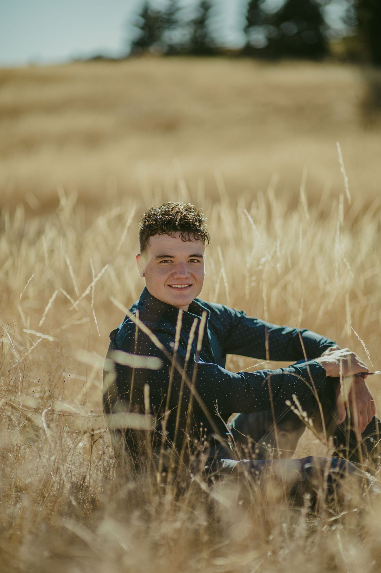 Portrait in golden wheat field with natural sunlight and shallow depth of field.