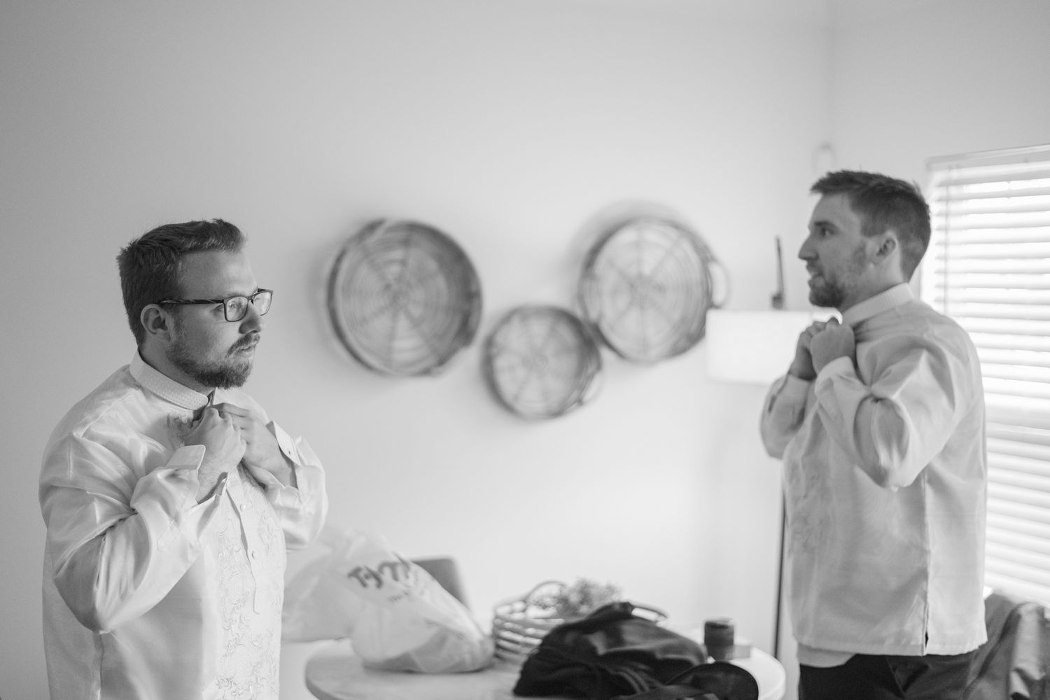 A series of black and white photographs arranged in a filmstrip-like sequence shows intimate moments during a wedding ceremony.