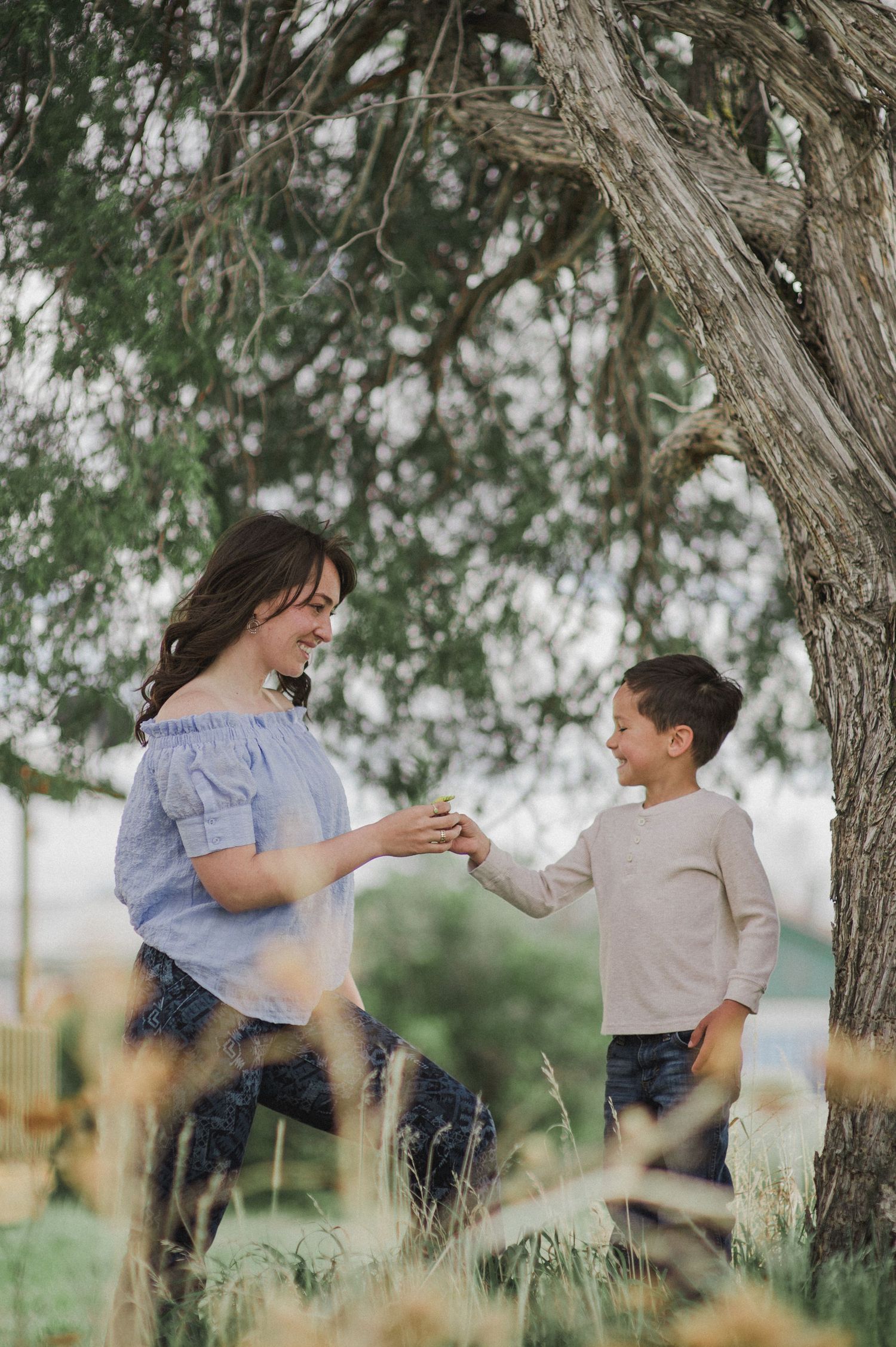 A playful collage of a couple twirling and dancing together under shaded trees during a photoshoot outdoors.