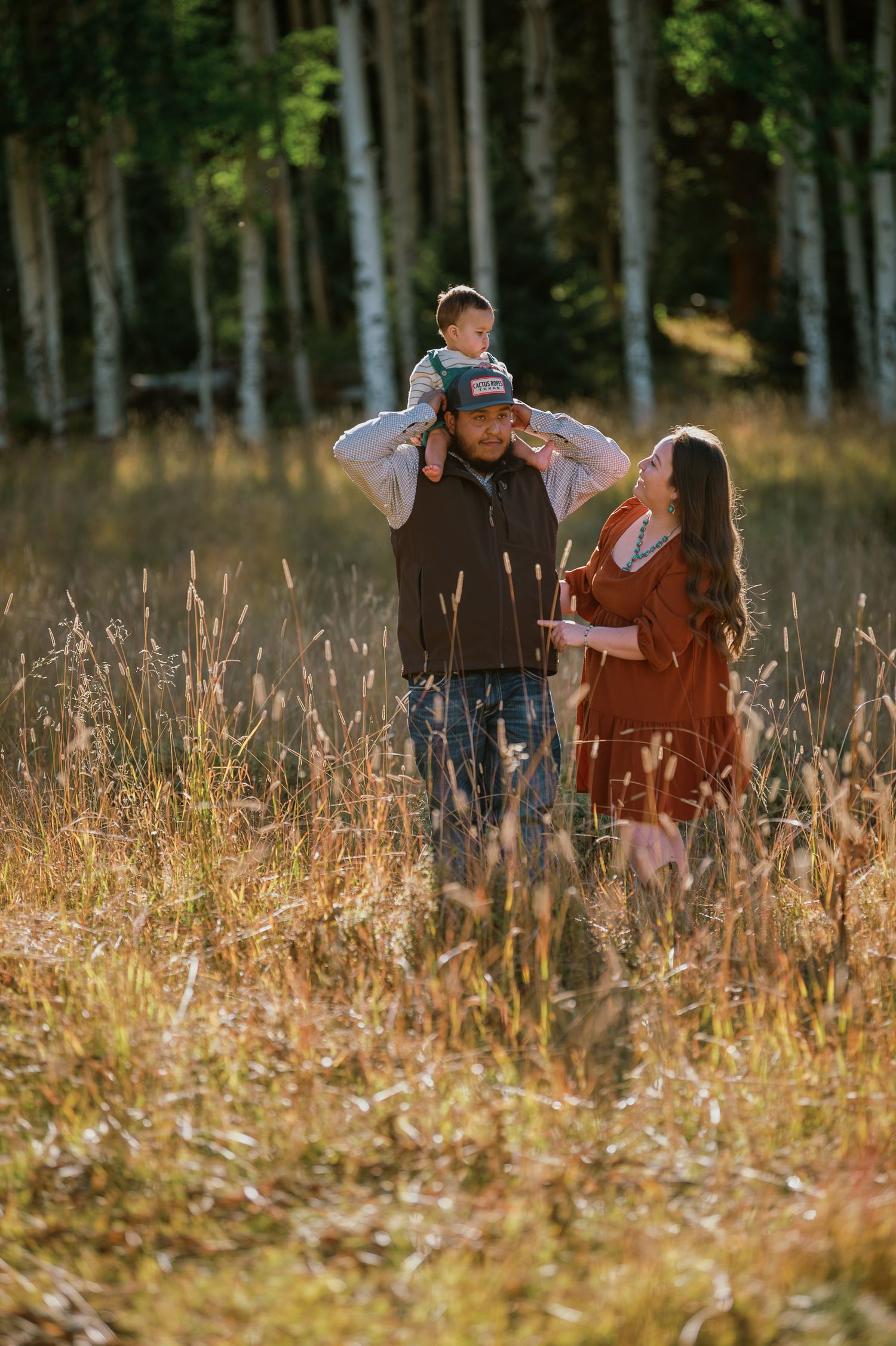Mom and dad walking with their toddler son in a serene forest setting near Santa Fe — heartfelt storytelling by Quiet Light by The Amoras.