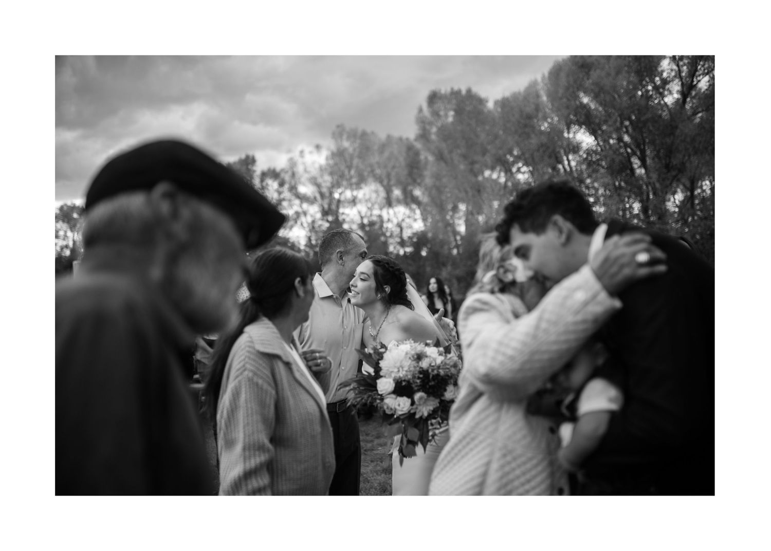 Black and white vintage photograph of guests celebrating at an outdoor gathering.