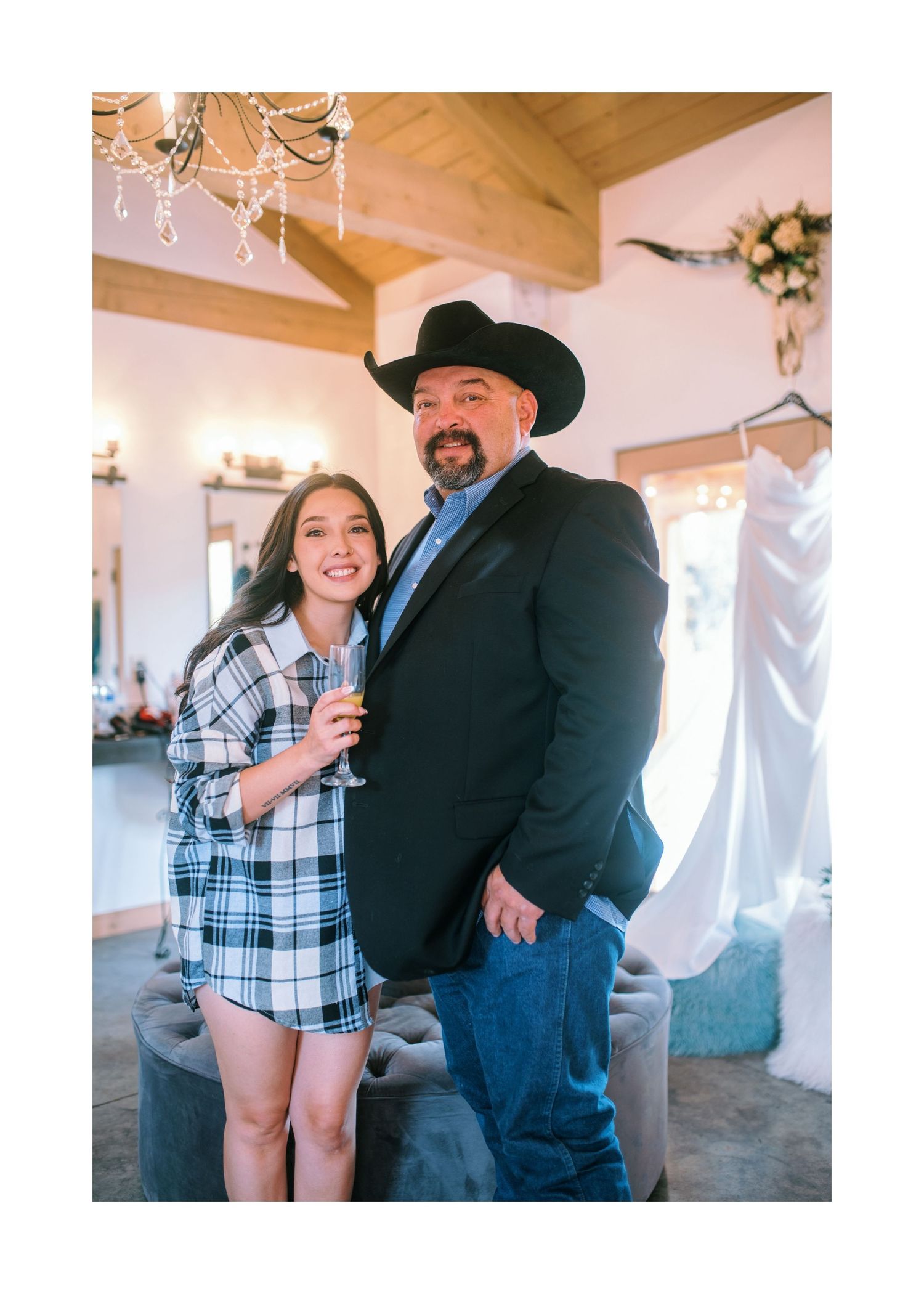 Two people share joyful moments in a rustic indoor venue during a special event celebration.
