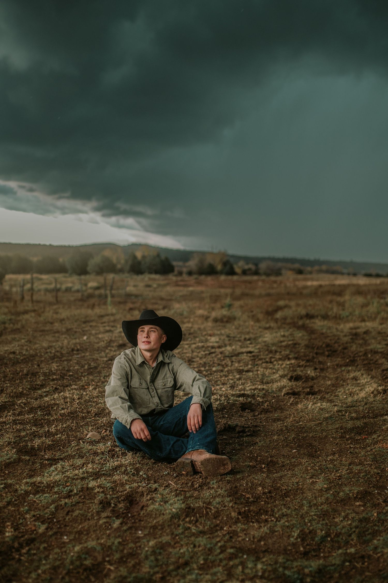 A dramatic series of photos shows a cowboy reclining on a rugged hillside under moody storm clouds at sunset.