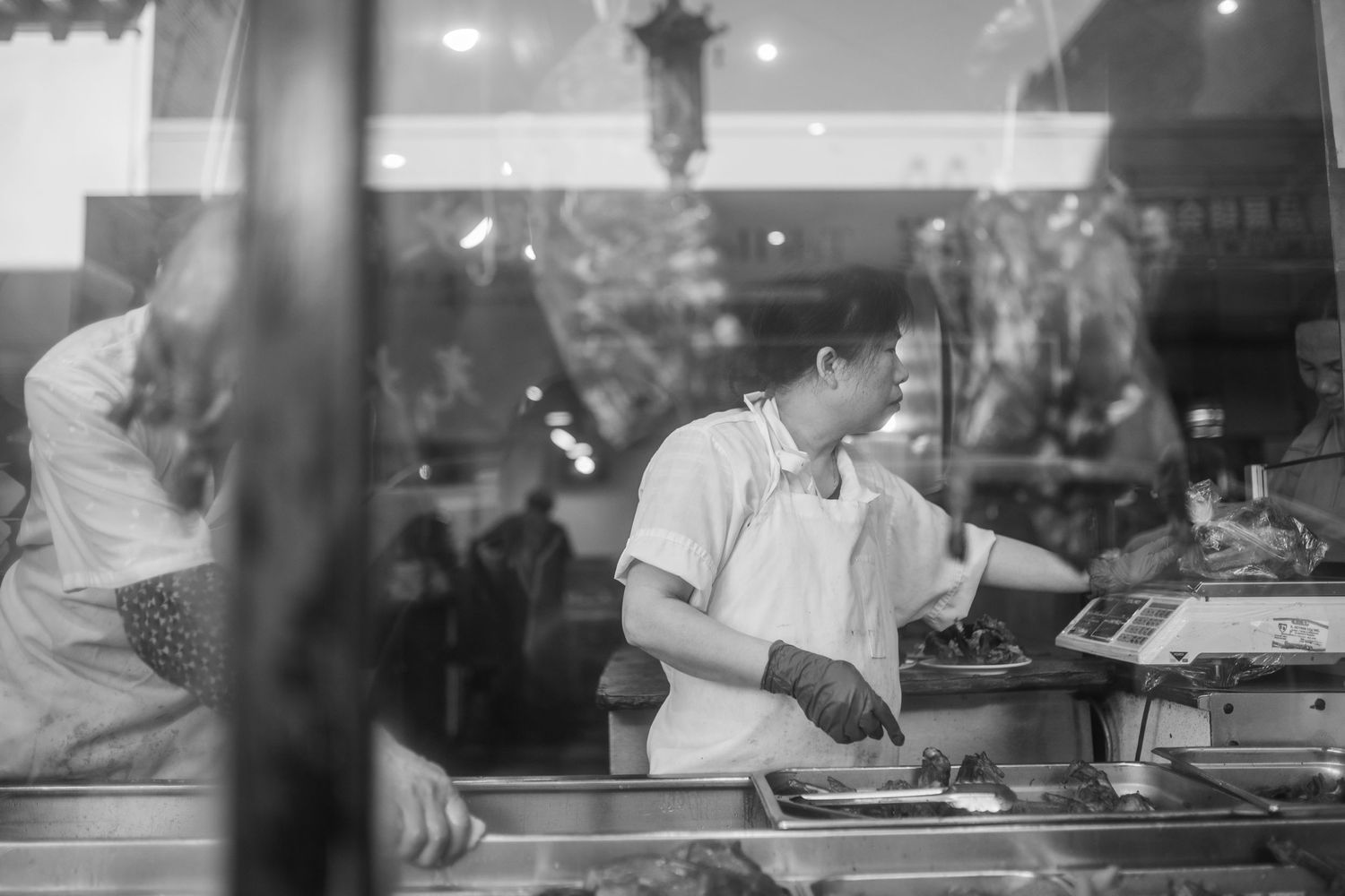 Close-up of skilled chefs cooking and preparing dishes in a busy restaurant kitchen.