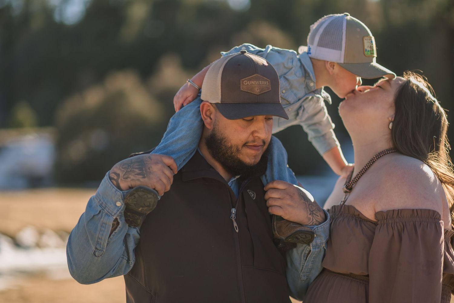 A couple shares an intimate moment while dancing together outdoors during golden hour.