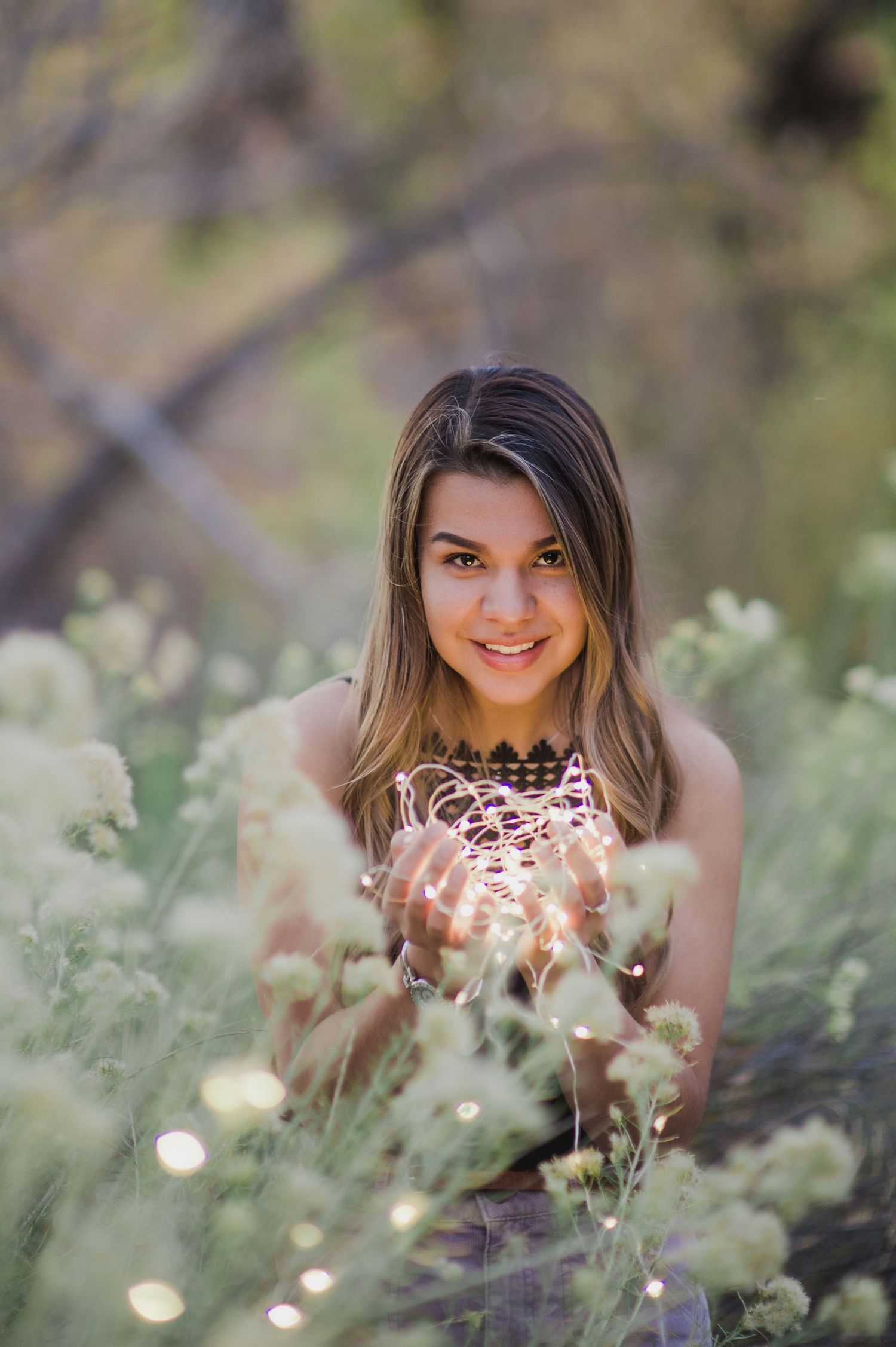 Soft focus portrait among delicate white wildflowers creating a whimsical outdoor scene.