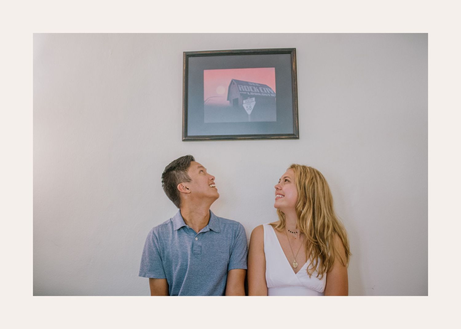 People dancing and laughing together against white wall while doing history repeating portraits.