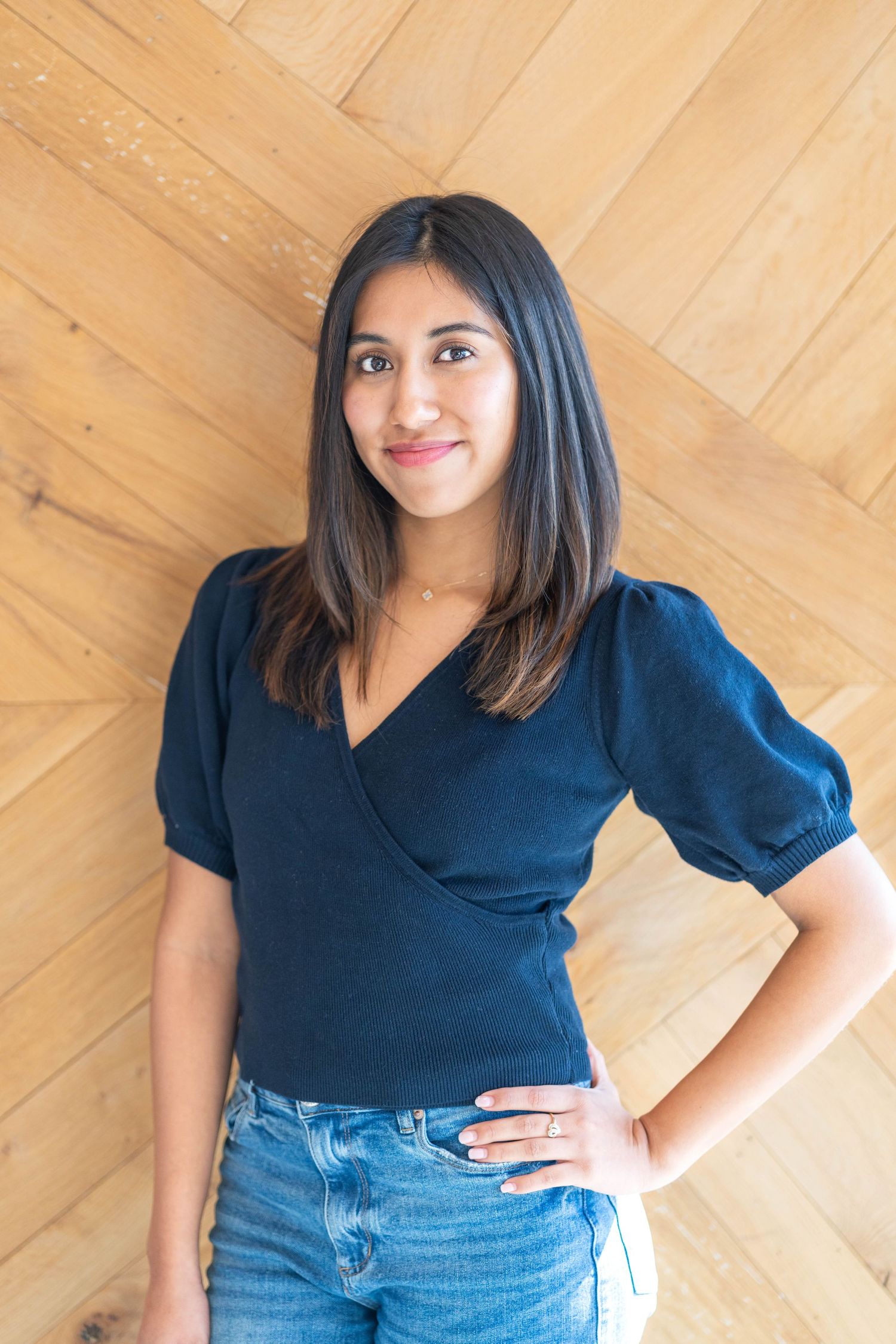 girl with a puffed, mid-sleeved blouse, girl wearing jeans, girl placing hands on her side
