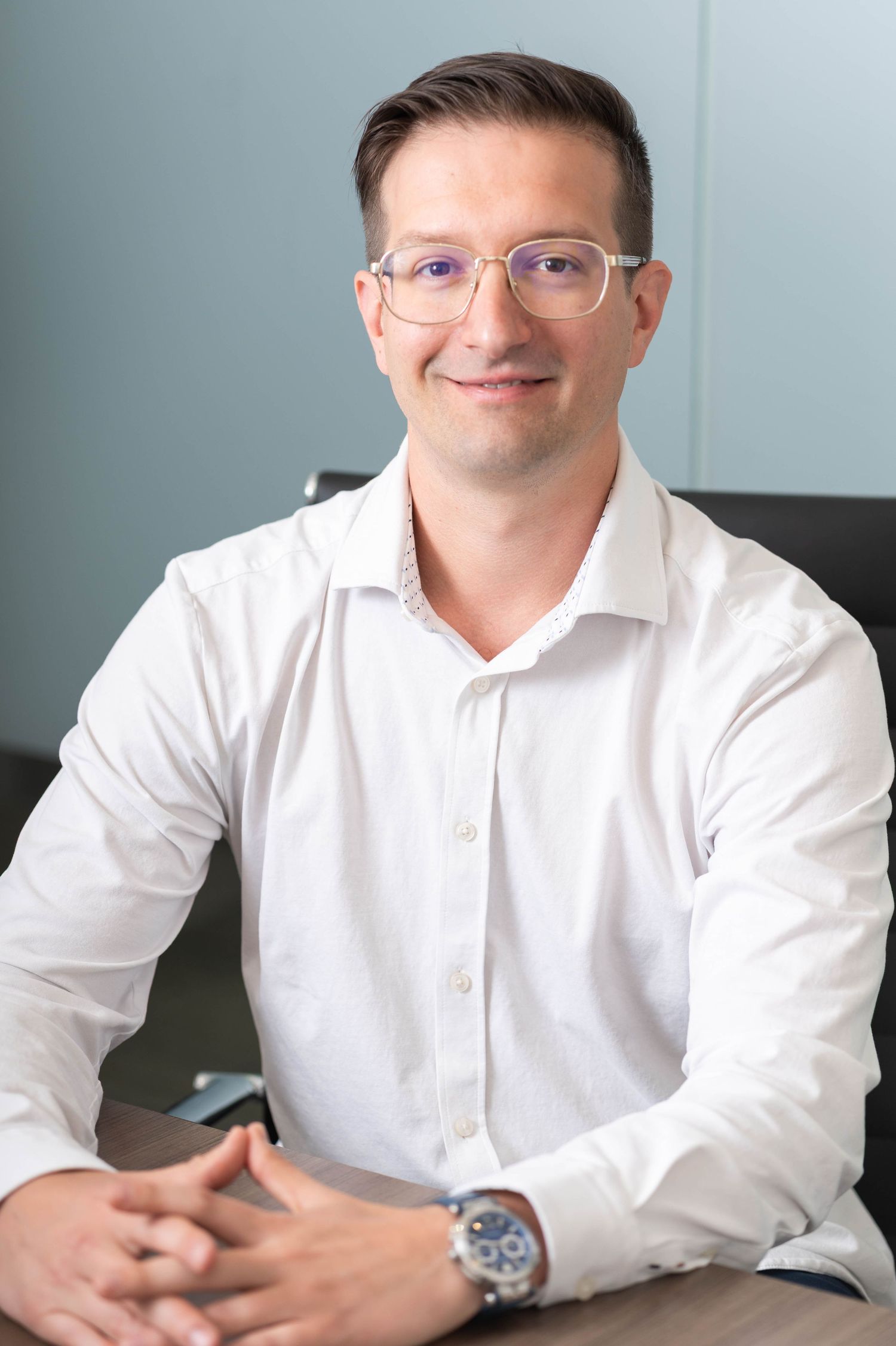 guy with glasses, wearing a white long-sleeved shirt