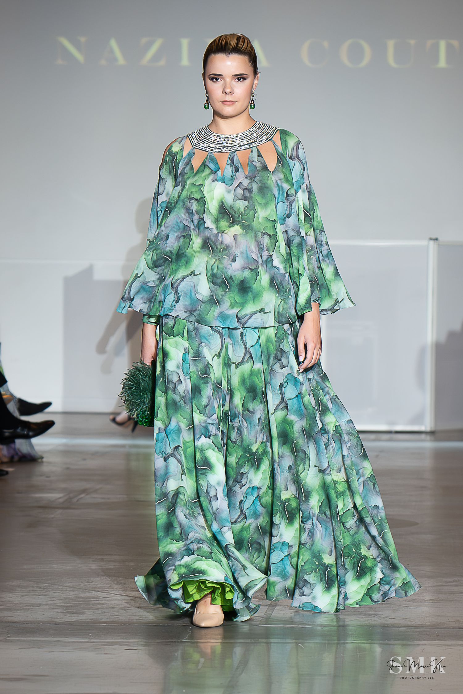 girl wearing a green two piece dress at a fashion show