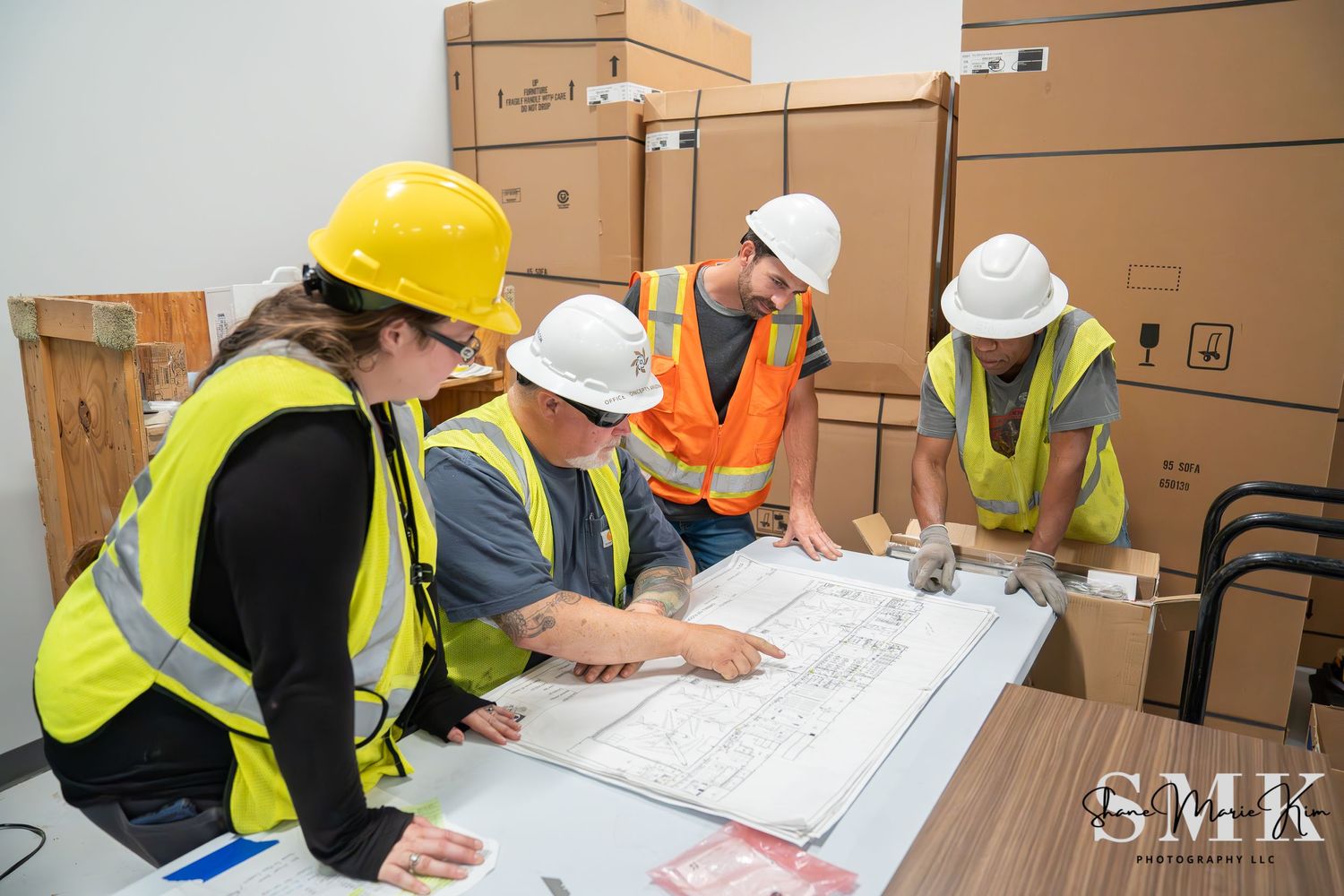 construction workers looking at a blue print
