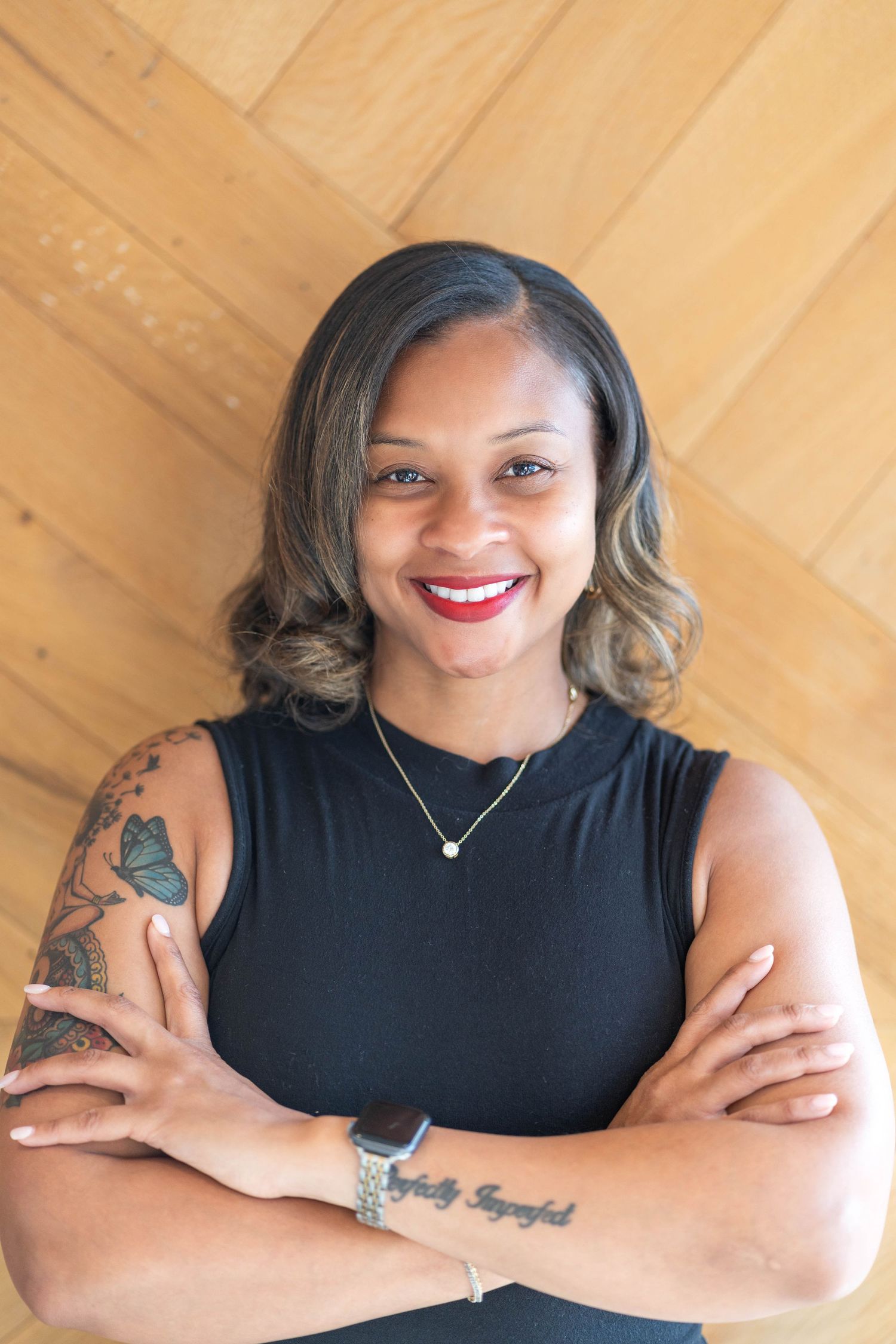 woman wearing a short sleeved dress, woman with tattoos, woman folding arms