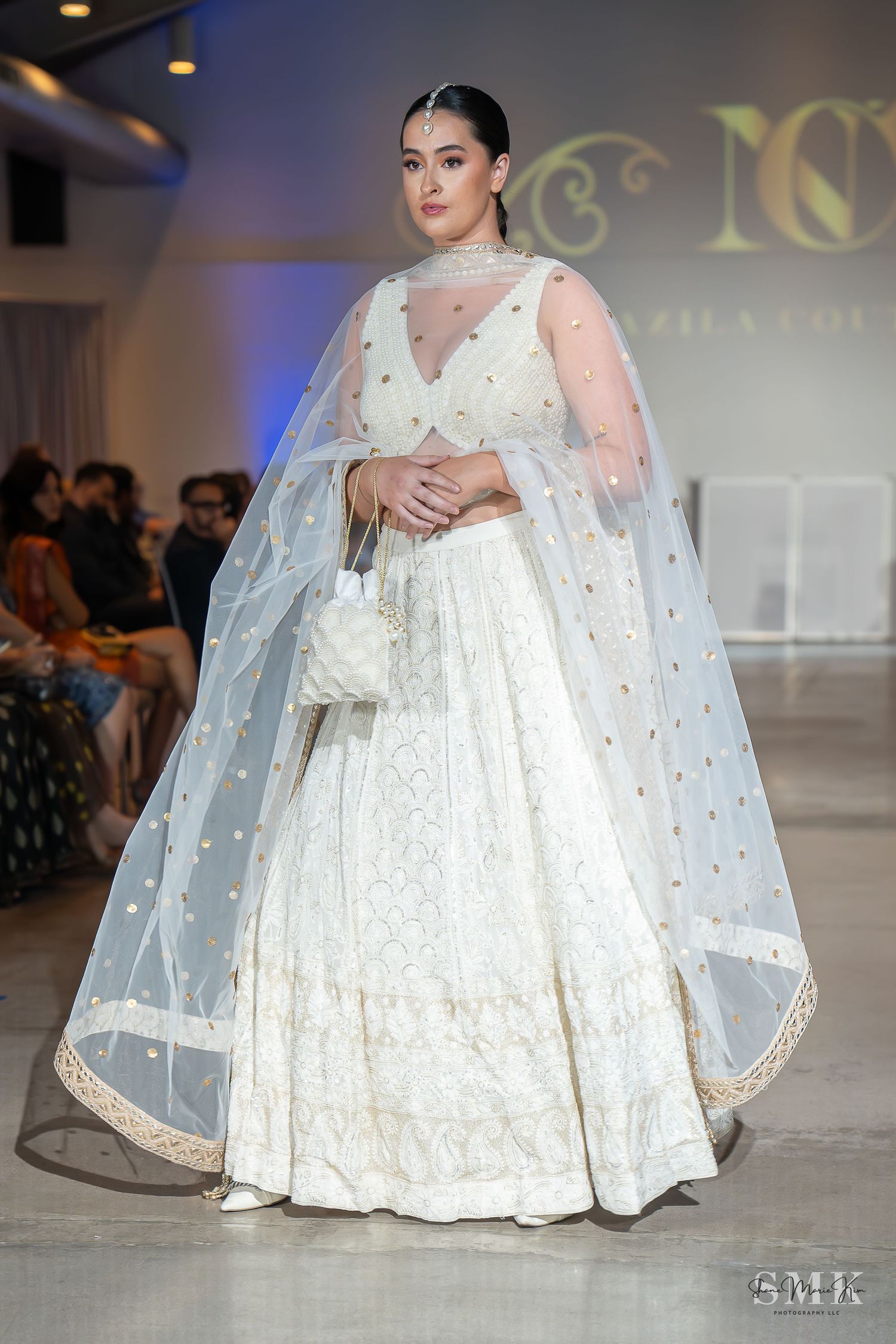 girl wearing a beautiful white dress at a fashion show