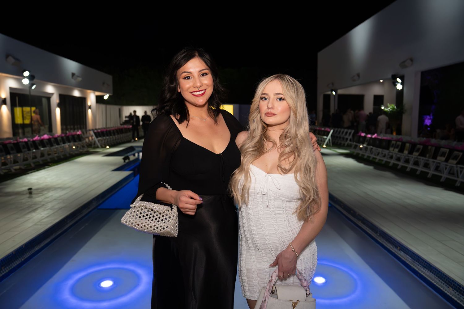 girl in black dress, girl in white dress, girls in front of a pool in scottsdale