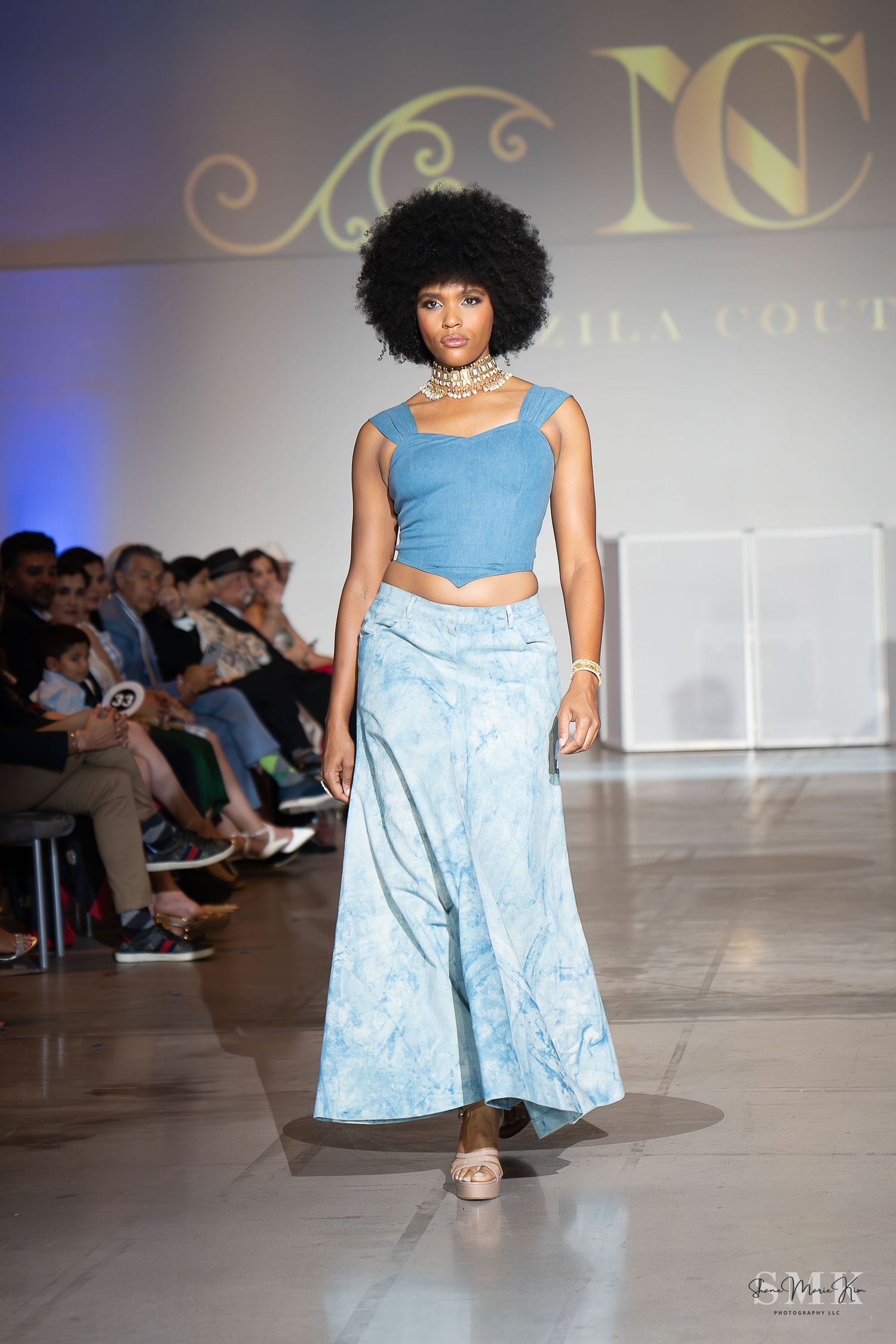 woman wearing a baby blue two piece outfit. Blue crop top with a maxi skirt