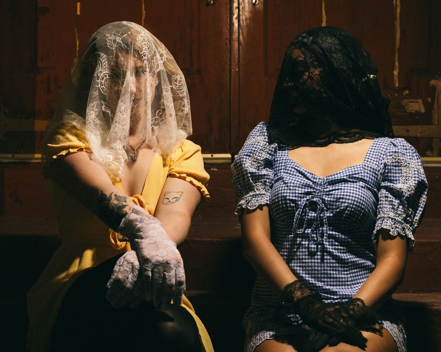 A moody artistic photo series showing figures in vintage-style dresses with dramatic lighting.