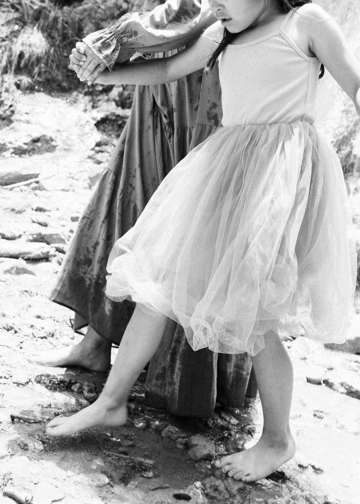 Series of ethereal photos featuring flowing white tulle dress details in snow.