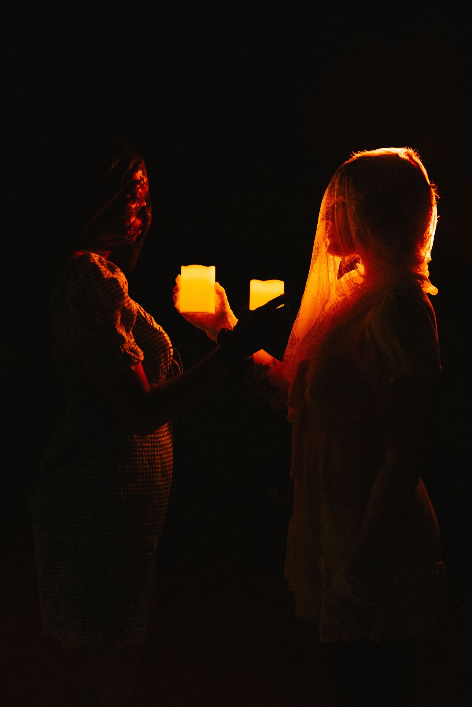 Dark atmospheric photos showing silhouettes of figures in dresses.