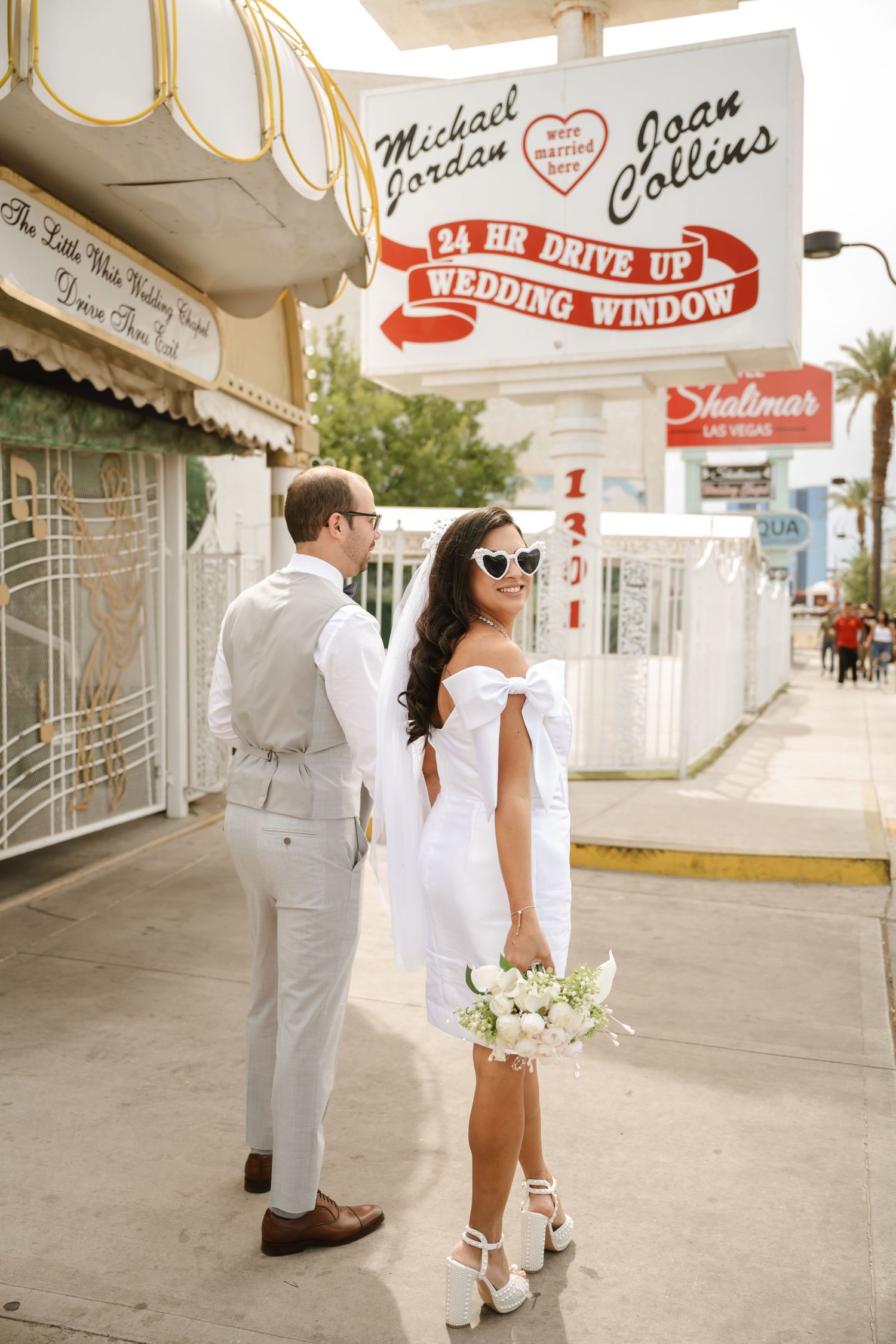 Wedding photos taken at a vintage Las Vegas chapel with retro signage.