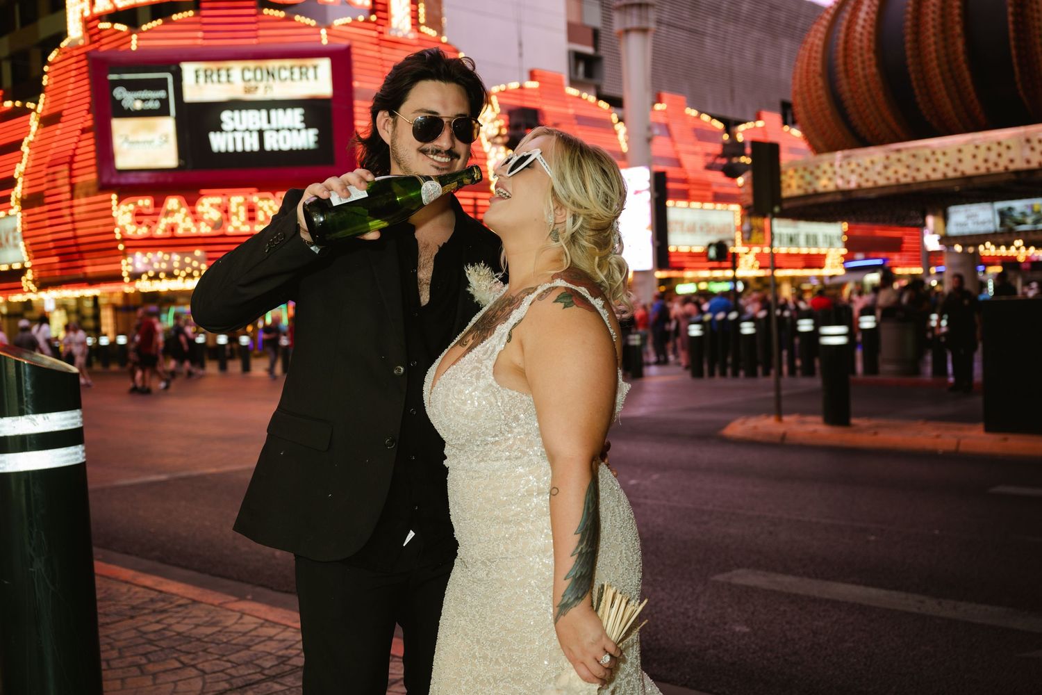 Wedding photos captured against vibrant red neon lights of Las Vegas.