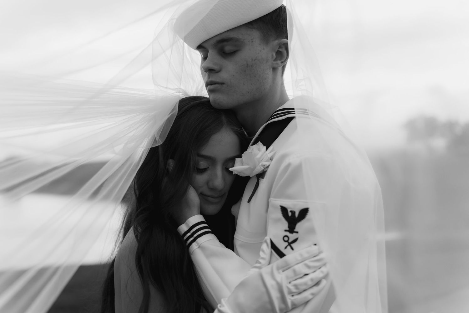 Black and white romantic wedding portraits showing intimate moments between a bride and sailor groom.