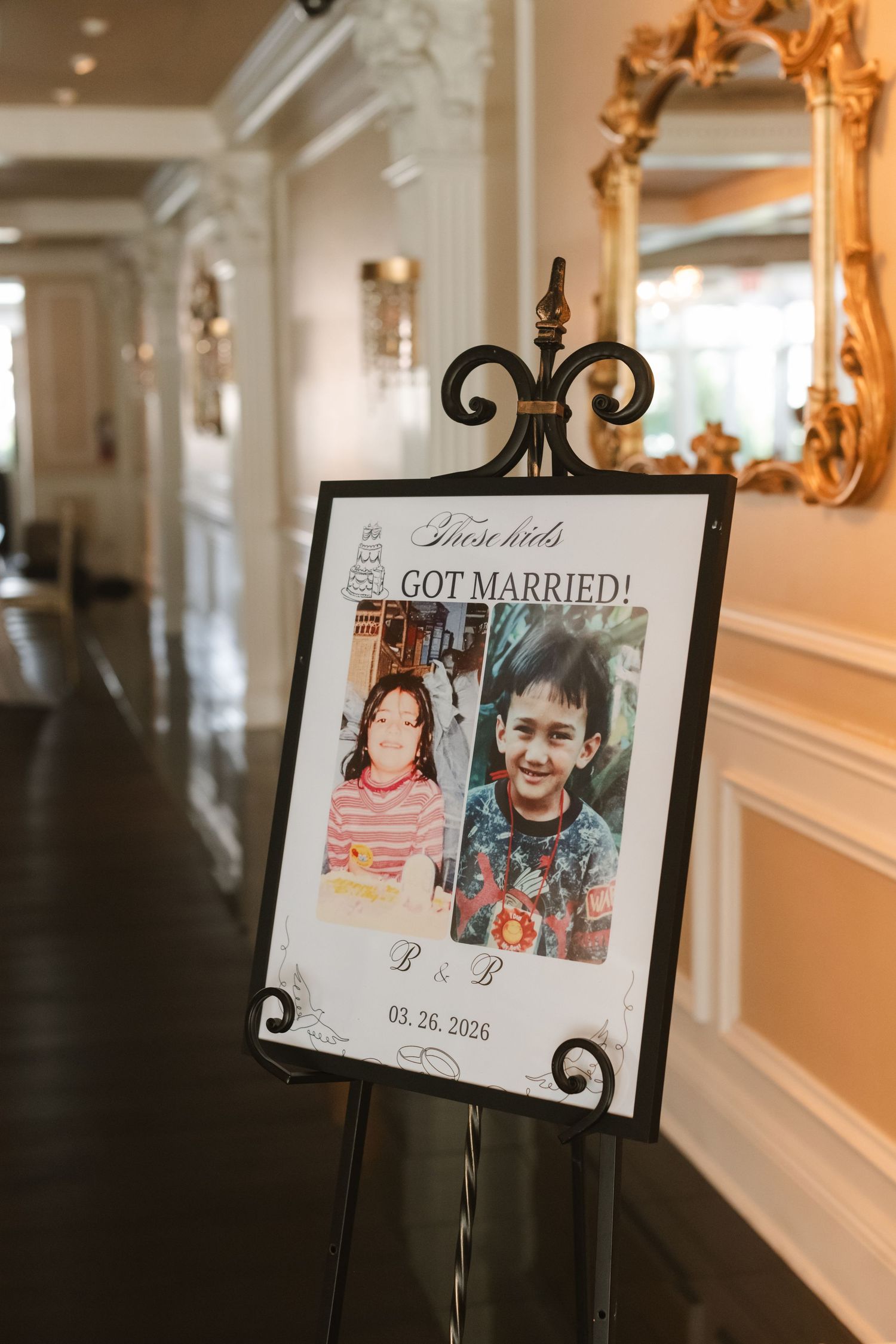 Wedding sign on easel displaying childhood photos of couple with text 
